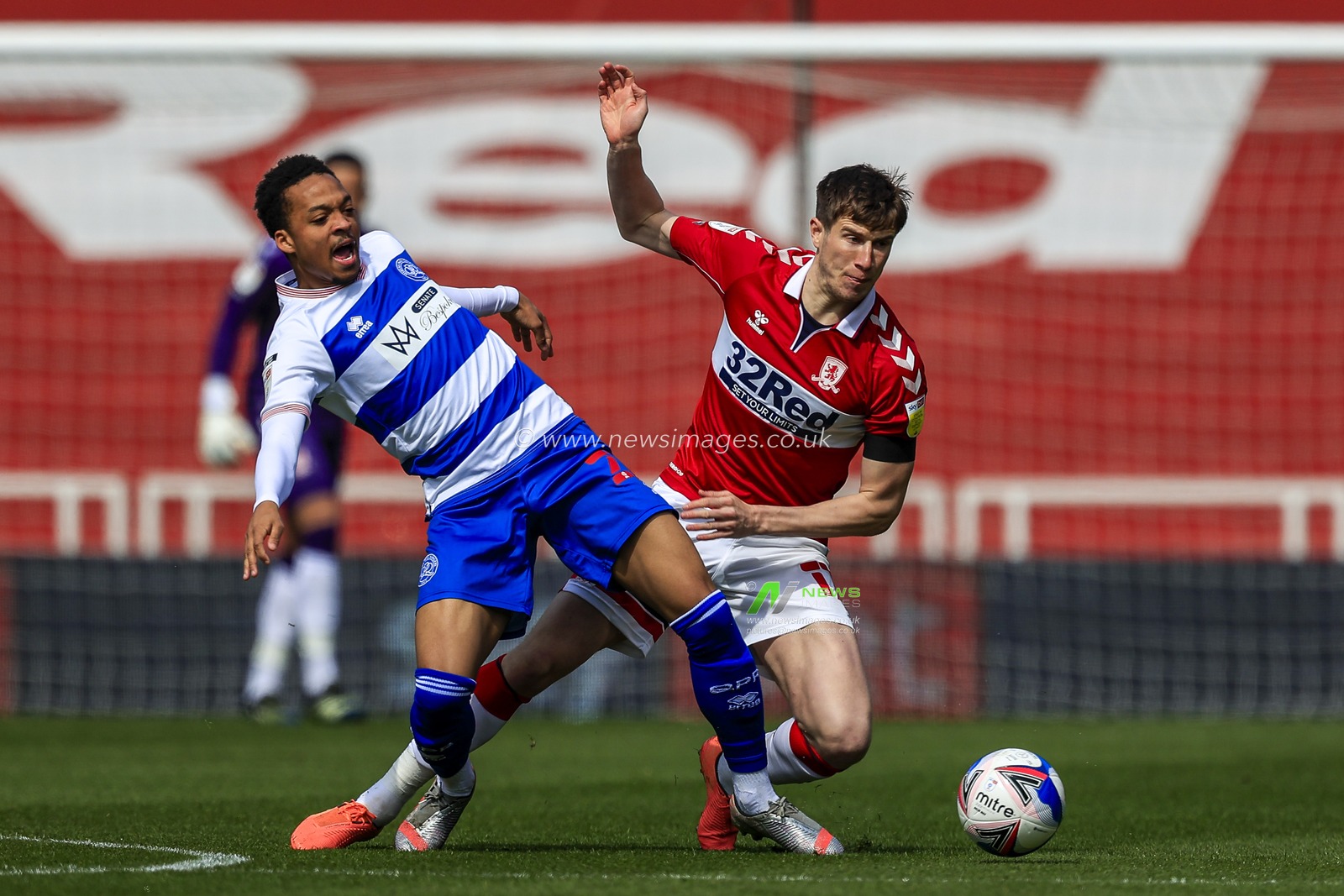 Paddy McNair #17 of Middlesbrough does enough to stop Chris Willock #21 of Queens Park Rangers controlling the ball