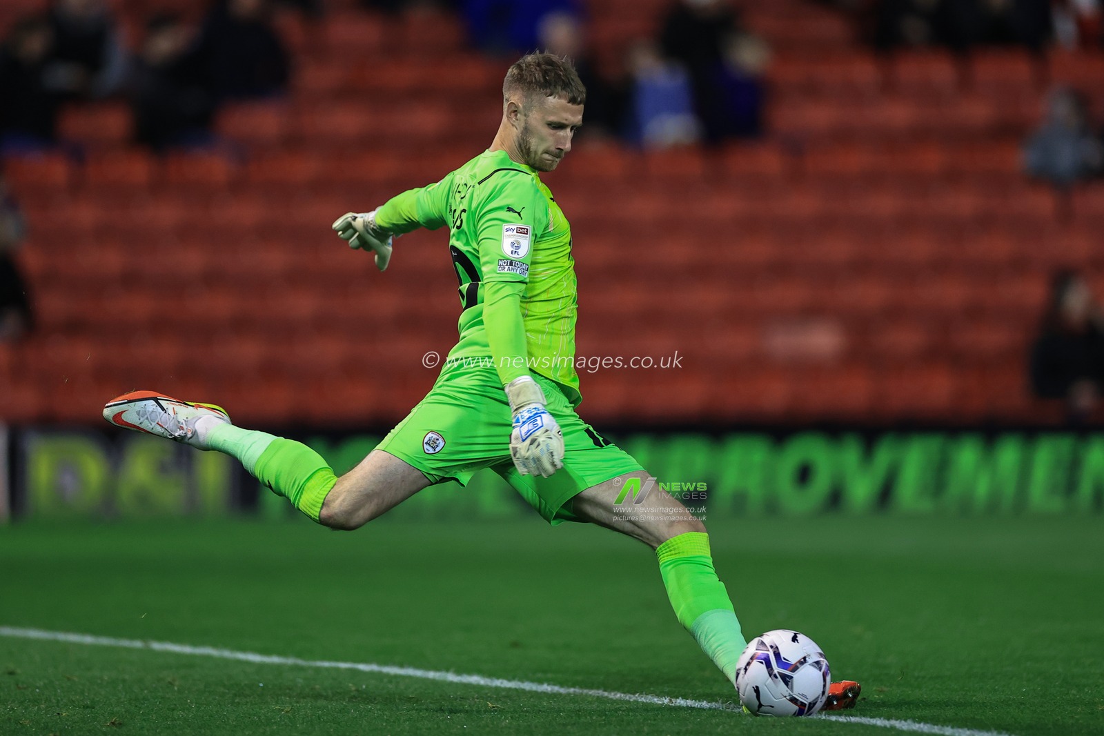 Bradley Collins #40 of Barnsley licks the ball out