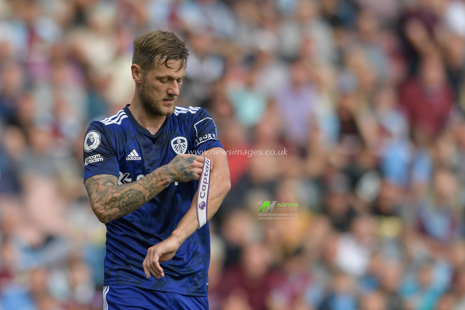 Liam Cooper #6 of Leeds United adjusts the captain armband