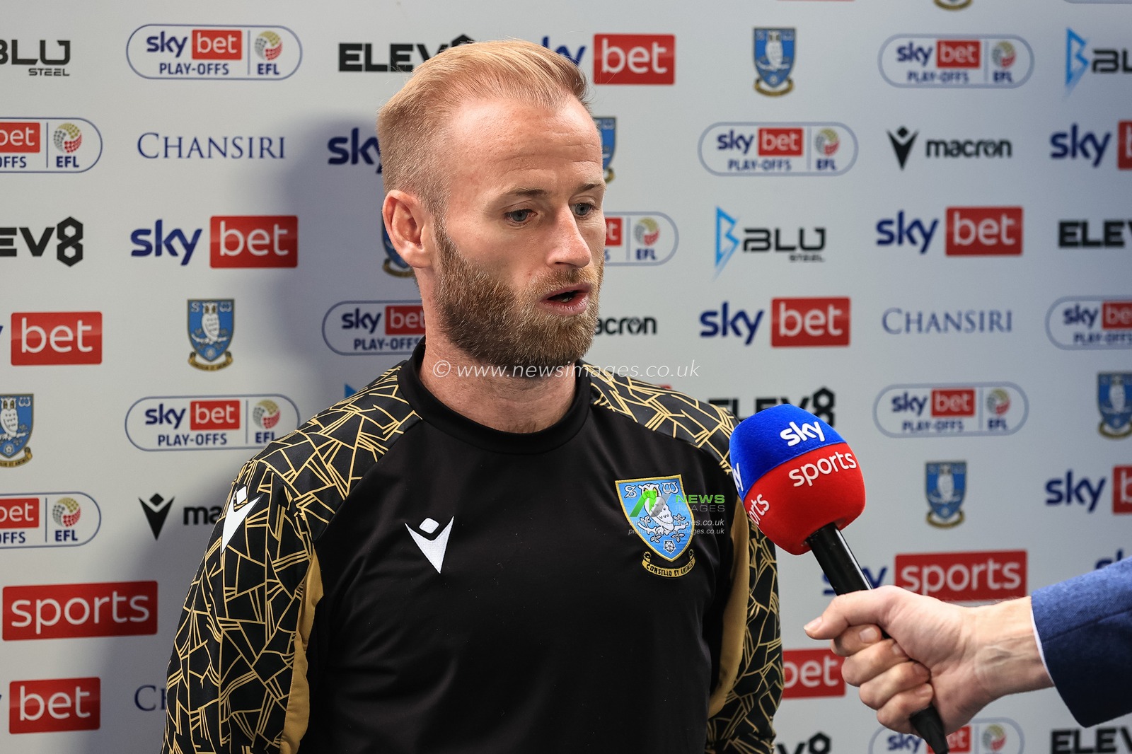 Barry Bannan #10 of Sheffield Wednesday speaks too Sky Sports Football
