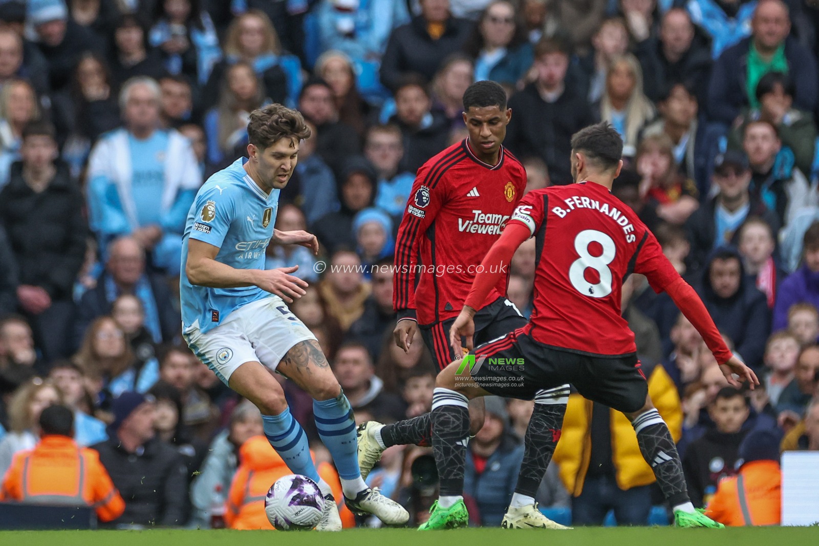 John Stones of Manchester City hold the ball challenged by Bruno Fernandes of Manchester United during the Premier League match Manchester City vs Manchester United at Etihad Stadium, Manchester, United Kingdom, 3rd March 2024

(Photo by Mark Cosgrove/News Images)