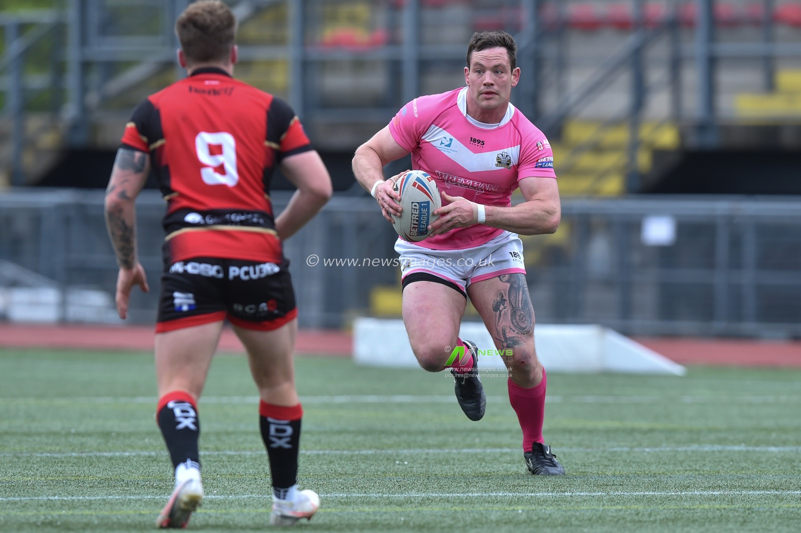 Rob Massam of North Wales Crusaders in action during the game ahead of Tom Firth of London Skolars
