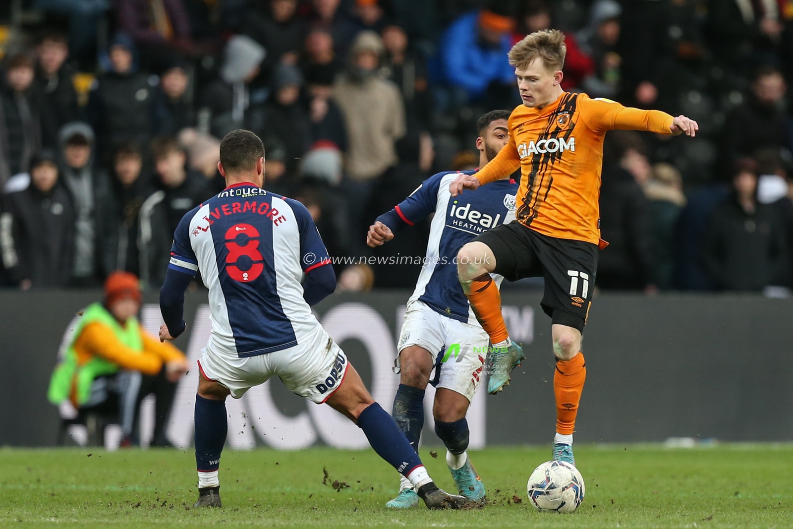 Keane Lewis-Potter #11 of Hull City protects the ball from Alex Mowatt #27 of West Bromwich Albion