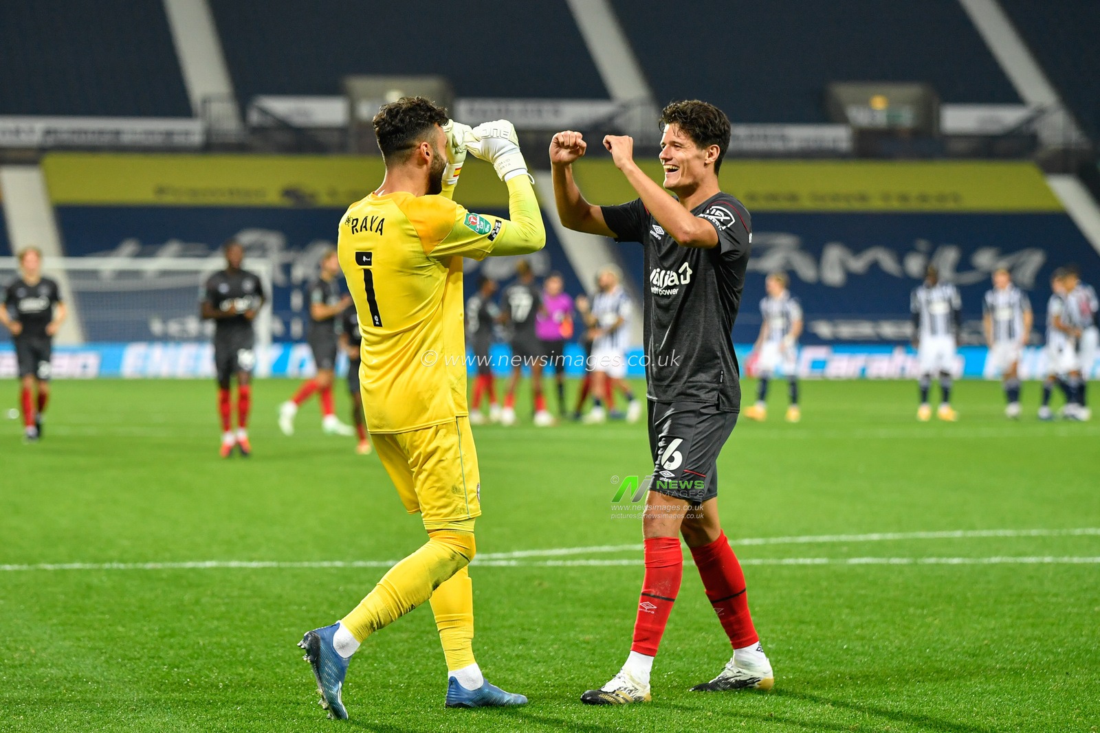 Christian Norgaard (6) of Brentford celebrates scoring the winning penalty to send Brentford through to the next round with David Raya Martin (1)