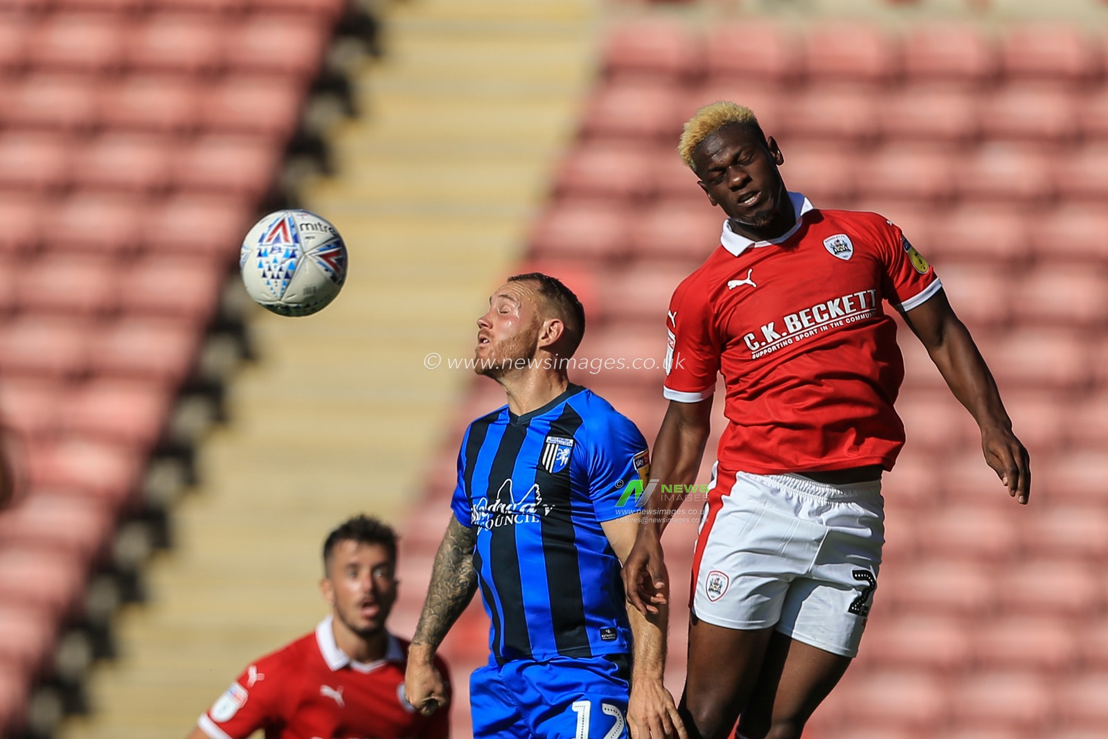 1st September 2018, Oakwell, Barnsley, England; Sky Bet League One, Barnsley v Gillingham ; Mamadou Thiam (26) of Barnsley and Barry Fuller (12) of Gillingham both go for the high ball