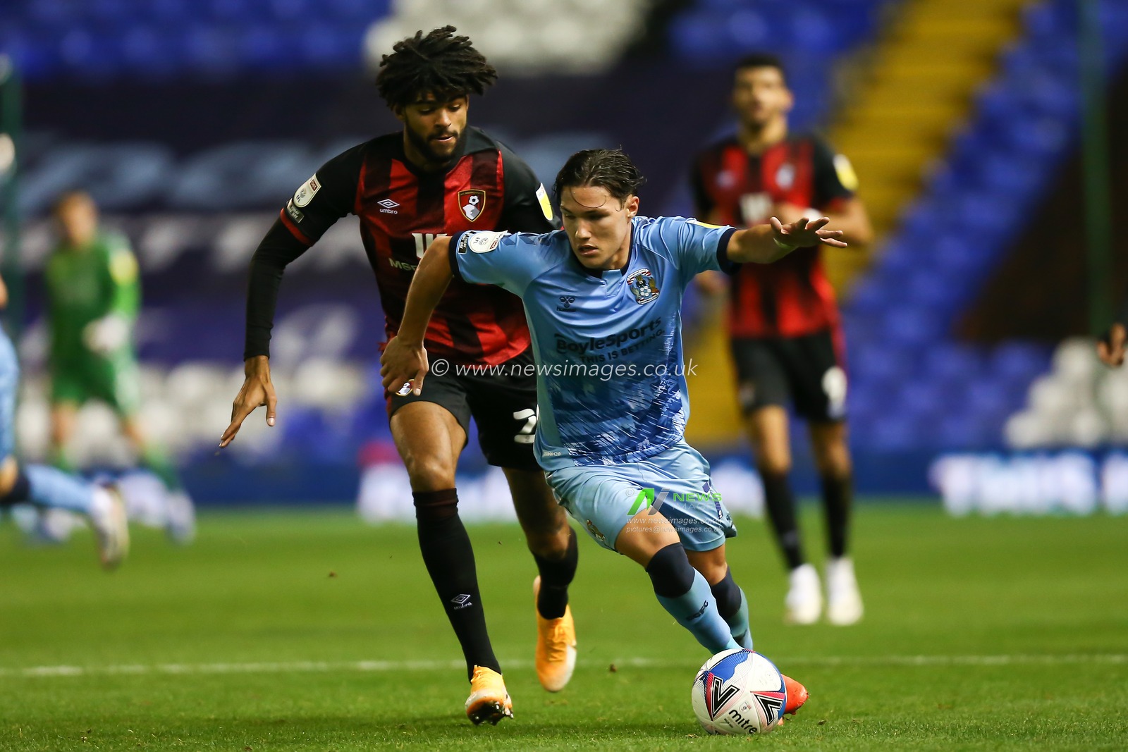 Callum O'Hare of Coventry City runs away from Philip Billing of AFC Bournemouth