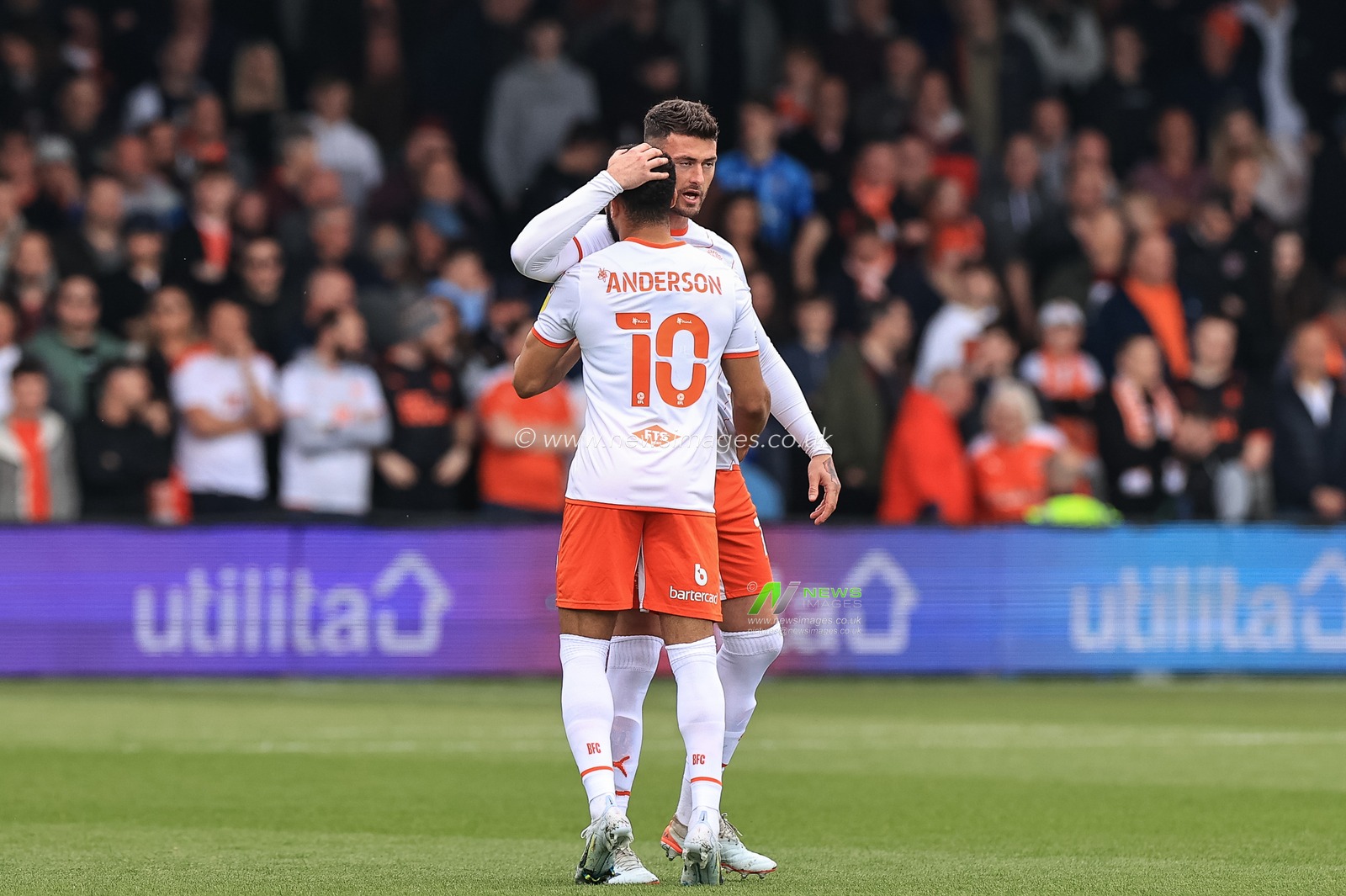 Gary Madine #14 of Blackpool embraces Keshi Anderson #10 of Blackpool