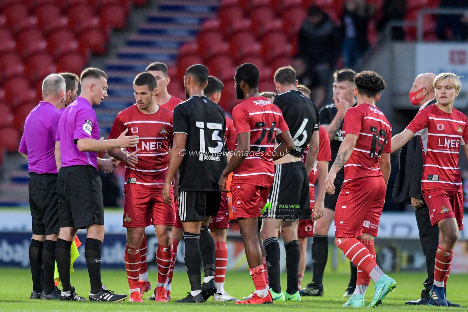 Players from both teams shake hands at the end of the game