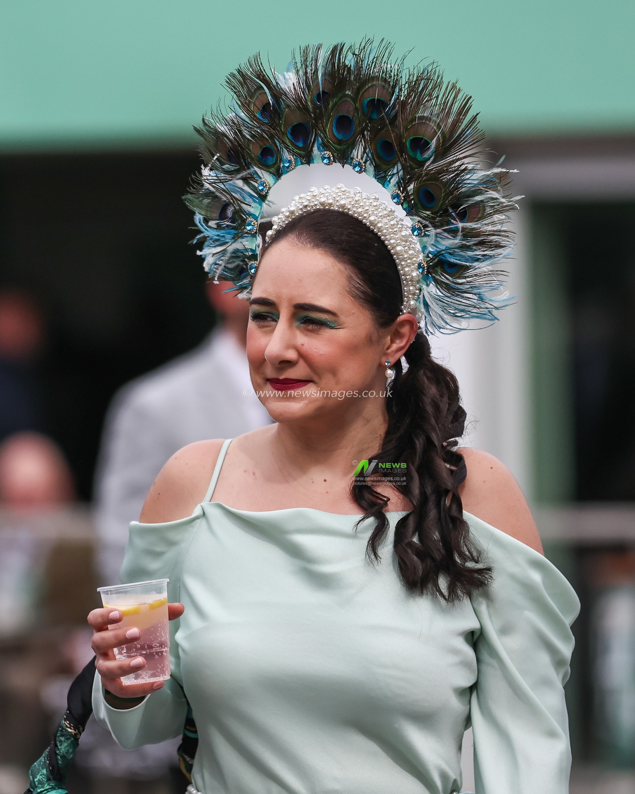ARacegoer having drinks on ladies day during the The Randox Grand National 2024 Ladies Day at Aintree Racecourse, Liverpool, United Kingdom, 12th April 2024

(Photo by Mark Cosgrove/News Images)
