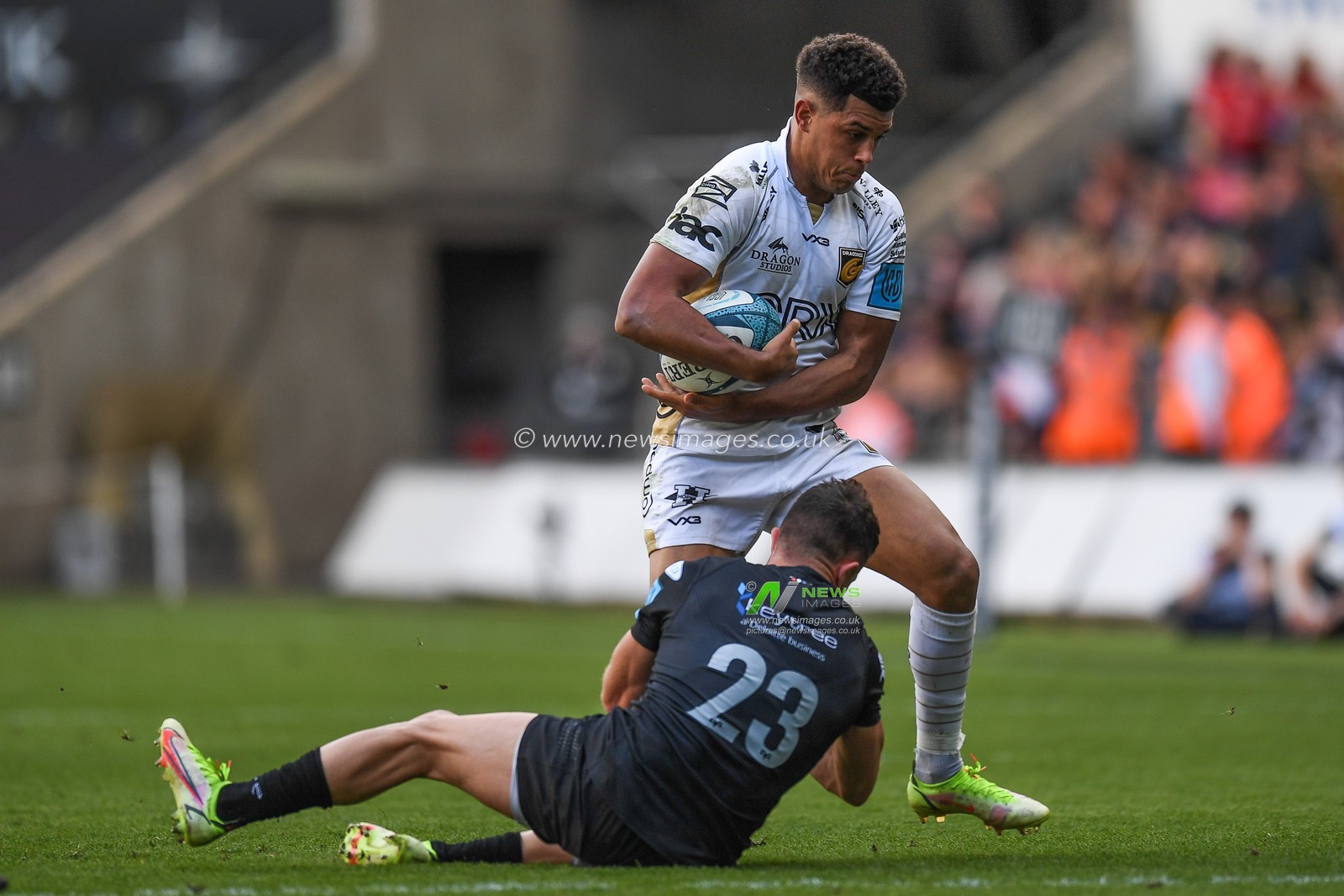 Luke Morgan of Ospreys, tackles Rio Dyer of Dragons,
