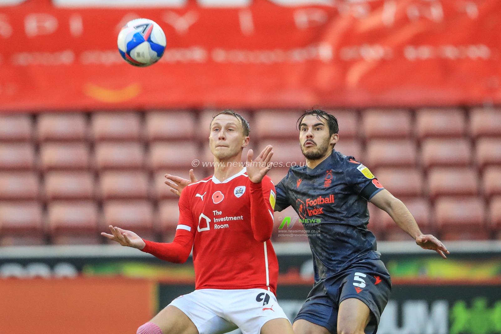 Cauley Woodrow #9 of Barnsley controls the ball as Yuri Ribeiro #5 of Nottingham Forest pressures