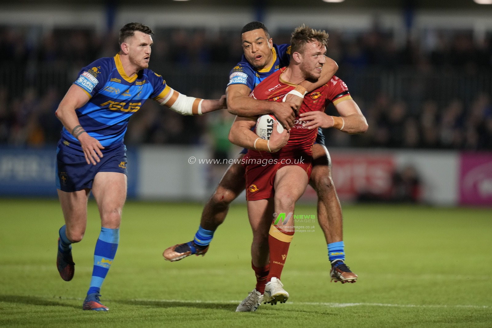 Reece Lyne #4 and Lee Gaskell #6 of Wakefield Trinity try to tackle Adam Keighran #3 of Catalans Dragons during the Betfred Super League  Round 1 match Wakefield Trinity vs Catalans Dragons at The Be Well Support Stadium, Wakefield, United Kingdom, 17th February 2023

(Photo by Steve Flynn/News Images)