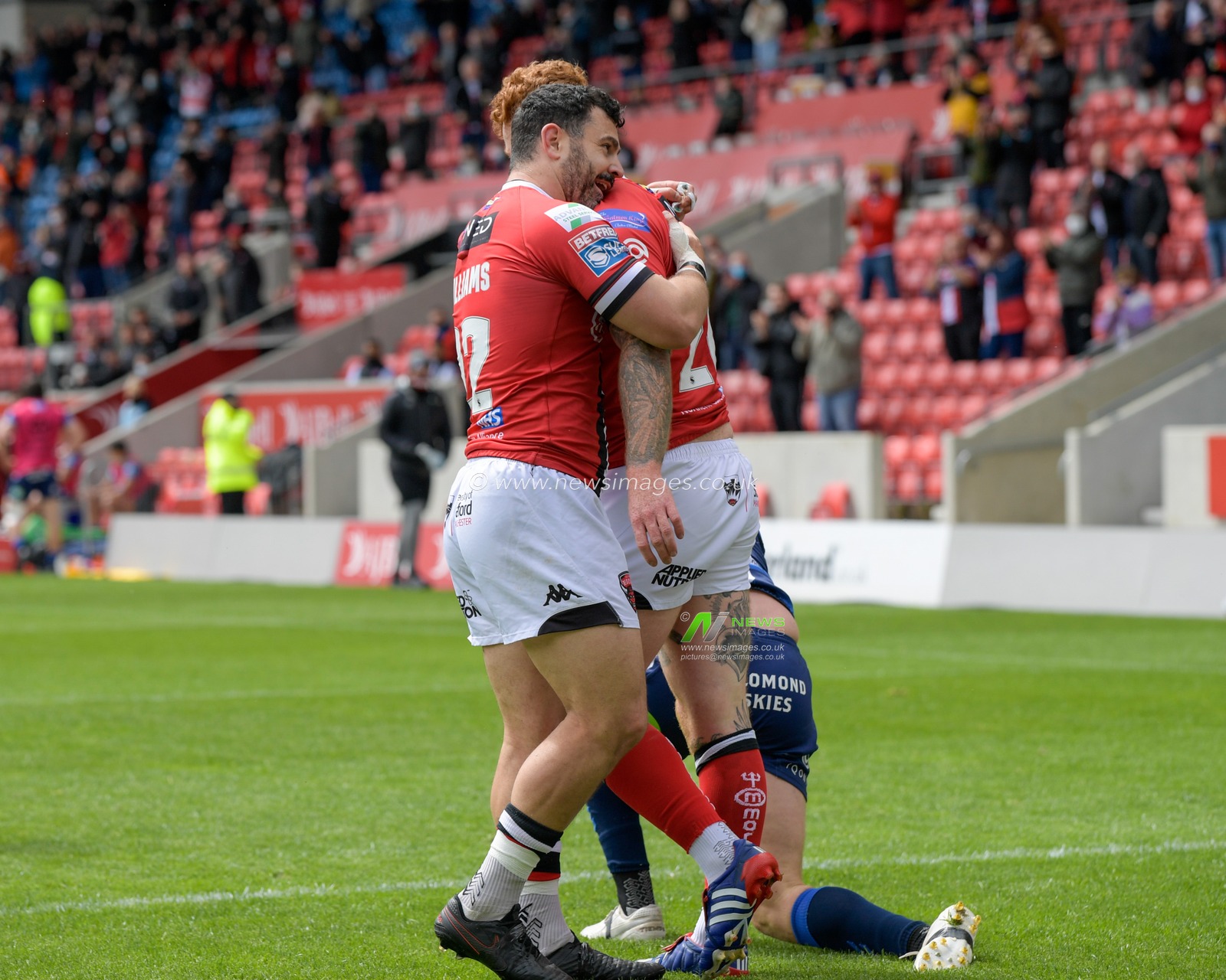 Harvey Livett (20) of Salford Red Devils celebrates scoring a try with Rhys Williams (22) of Salford Red Devils to make it 4-0