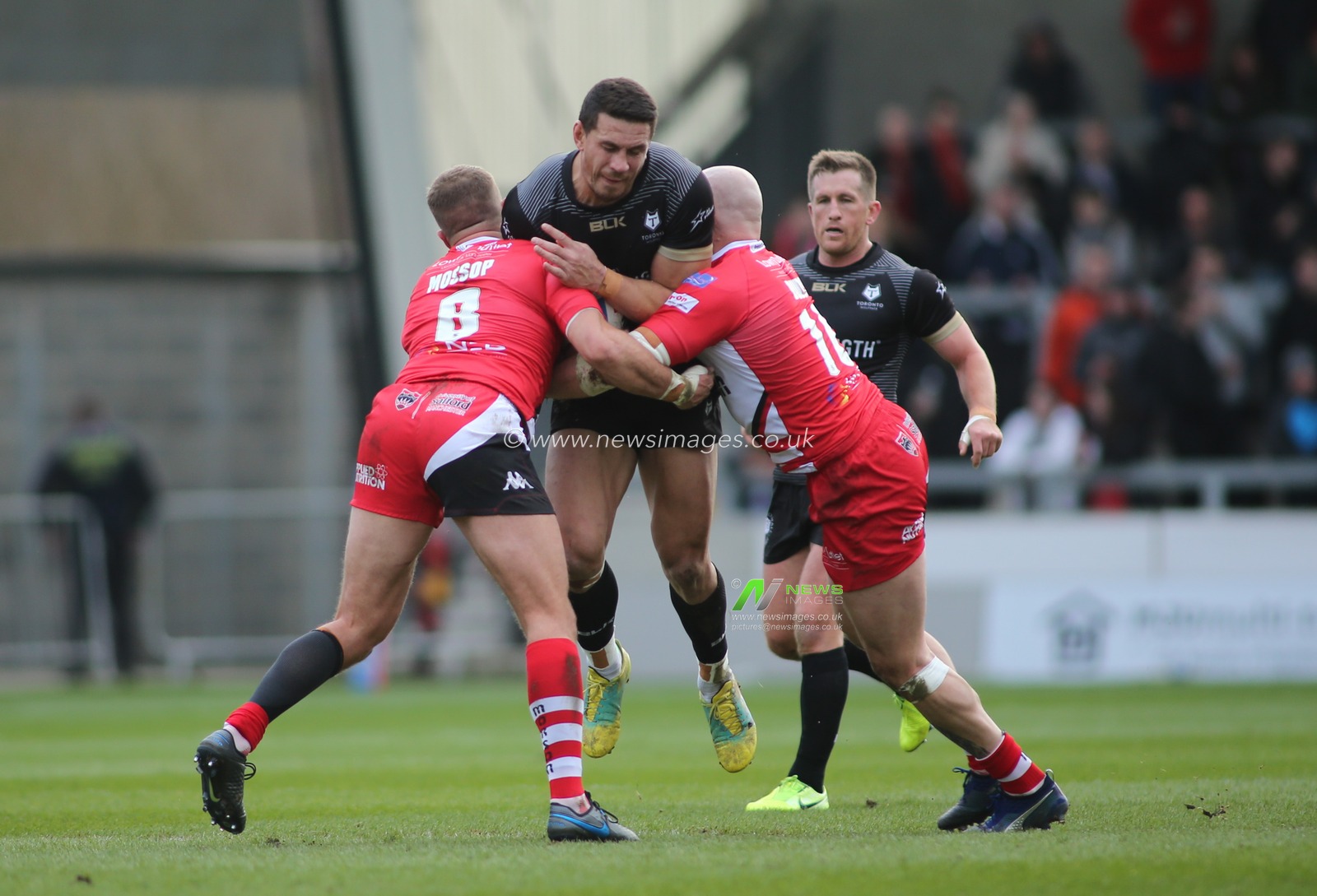 8th February 2020, AJ Bell Stadium, Eccles, England; Betfred Super League, Salford Red Devils v Toronto Wolfpack : Sonny Bill Williams of Toronto Wolfpack tackled by Lee Mossop(L) and Gil Dudson (R) of Salford Red Devils.