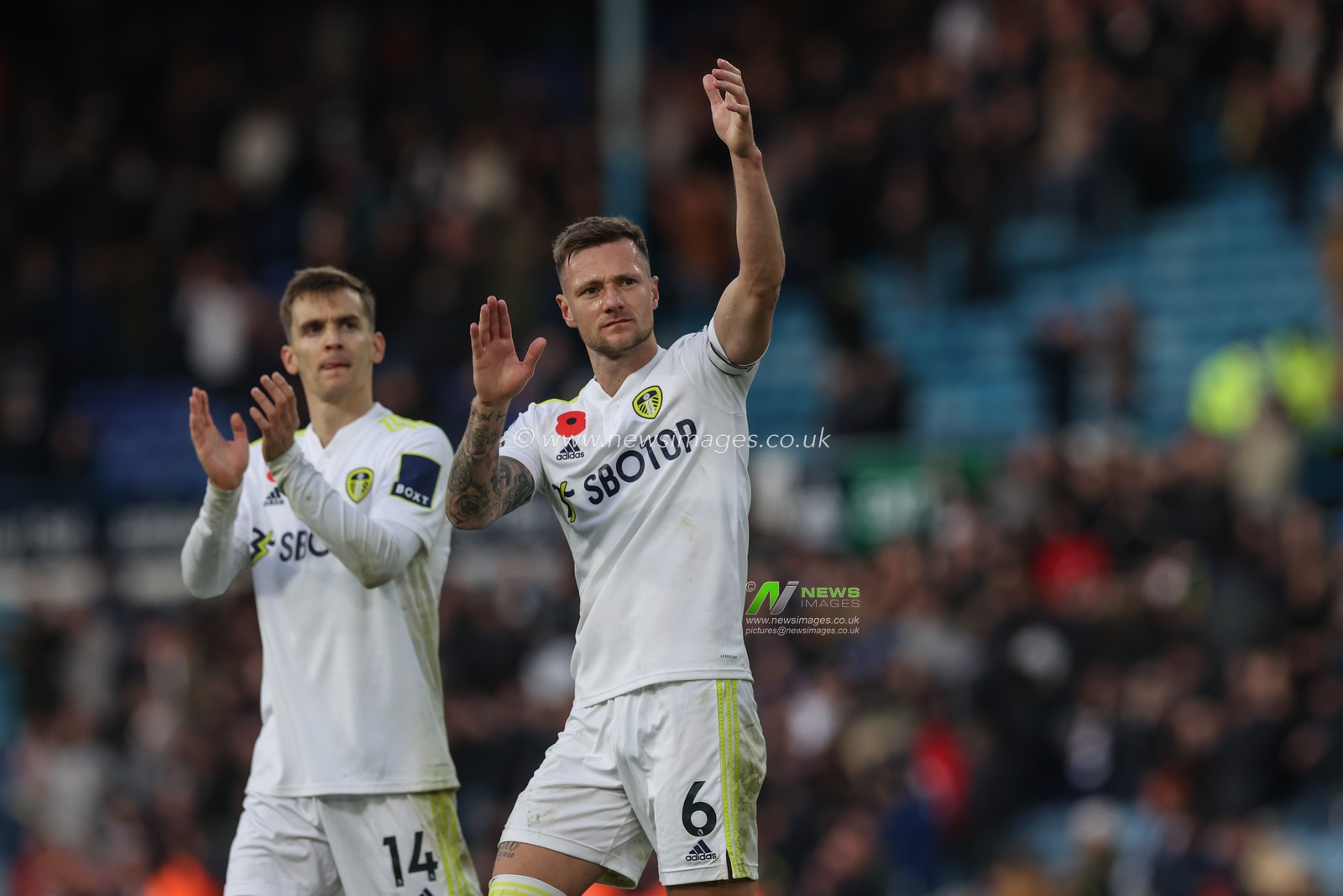 Liam Cooper #6 of Leeds United applauds the fans
