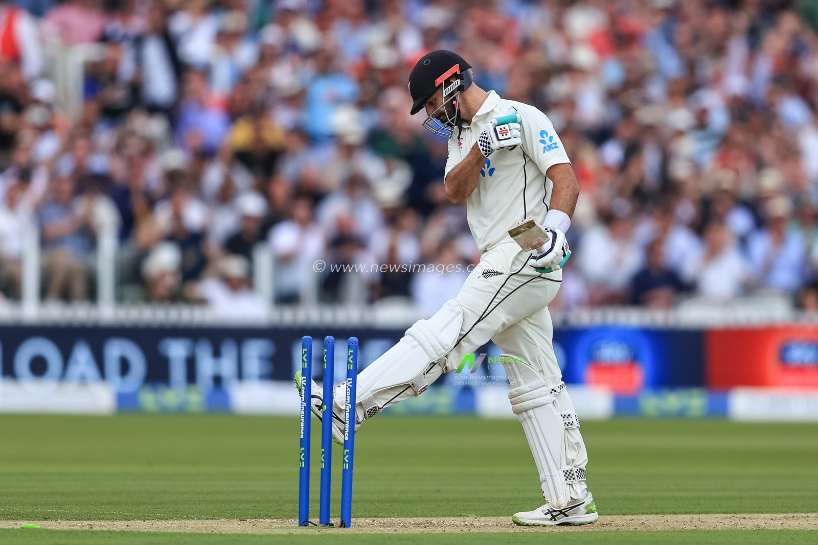 Daryl Mitchell #75 of New Zealand kicks the wicket as heâ€™s bowled out