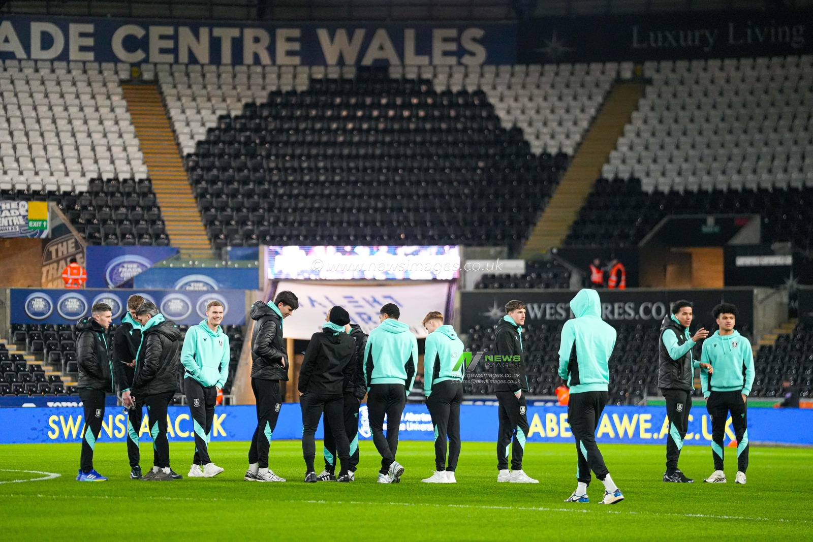 Sheffield Wednesday players inspect the pitch ahead of the Sky Bet Championship match Swansea City vs Sheffield Wednesday at Swansea.com Stadium, Swansea, United Kingdom, 12th February 2025

(Photo by Andrew Lewis/News Images)