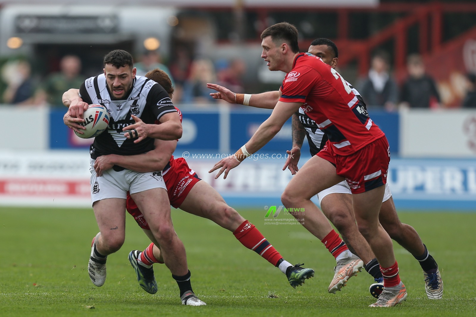 Jake Connor #1 of Hull FC is stopped by the Hull KR defence