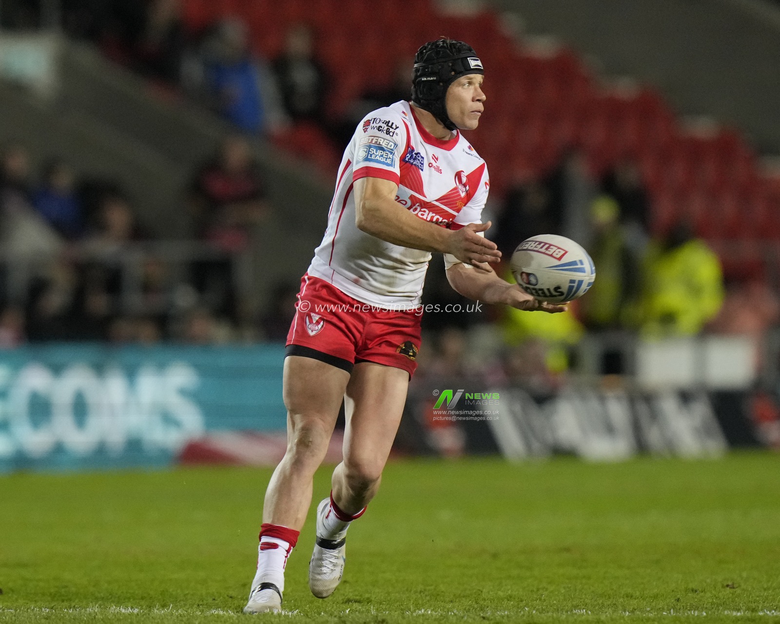 Jonny Lomax of St. Helens passes the ball during the Betfred Super League  Round 8 match St Helens vs Hull FC at Totally Wicked Stadium, St Helens, United Kingdom, 19th April 2024

(Photo by Steve Flynn/News Images)