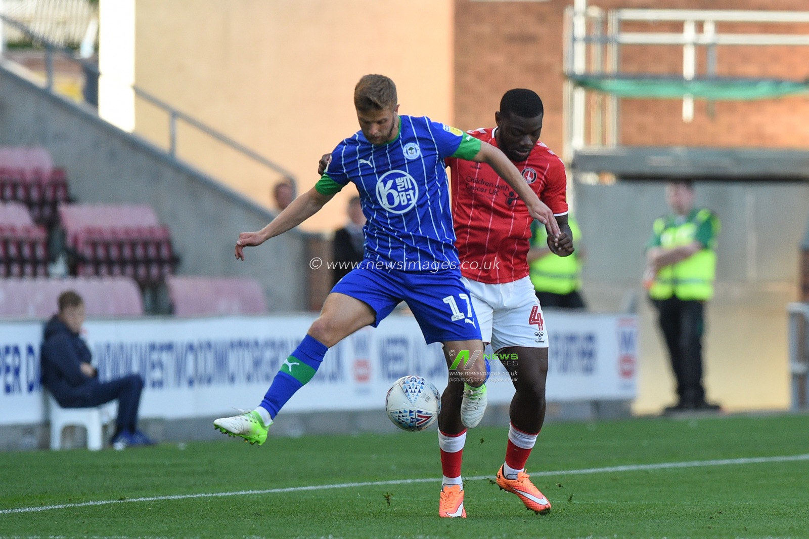 21st September 2019, DW Stadium, Wigan, England; Sky Bet Championship Football, Wigan Athletic vs Charlton Athletic ; Adedeji Oshilaja (4) of Charlton Athletic and Michael Jacobs (17) of Wigan Athletic contest the ball


Credit: Richard Long/News Images

English Football League images are subject to DataCo Licence