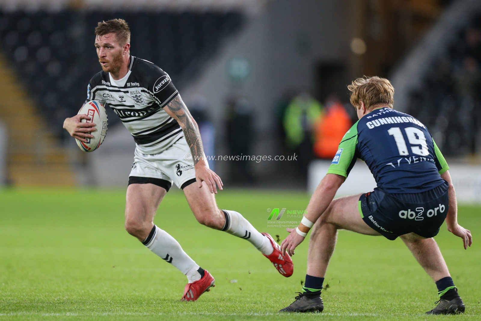 Marc Sneyd (7) of Hull FC looks for a way past James Cunningham (19) of Huddersfield Giants