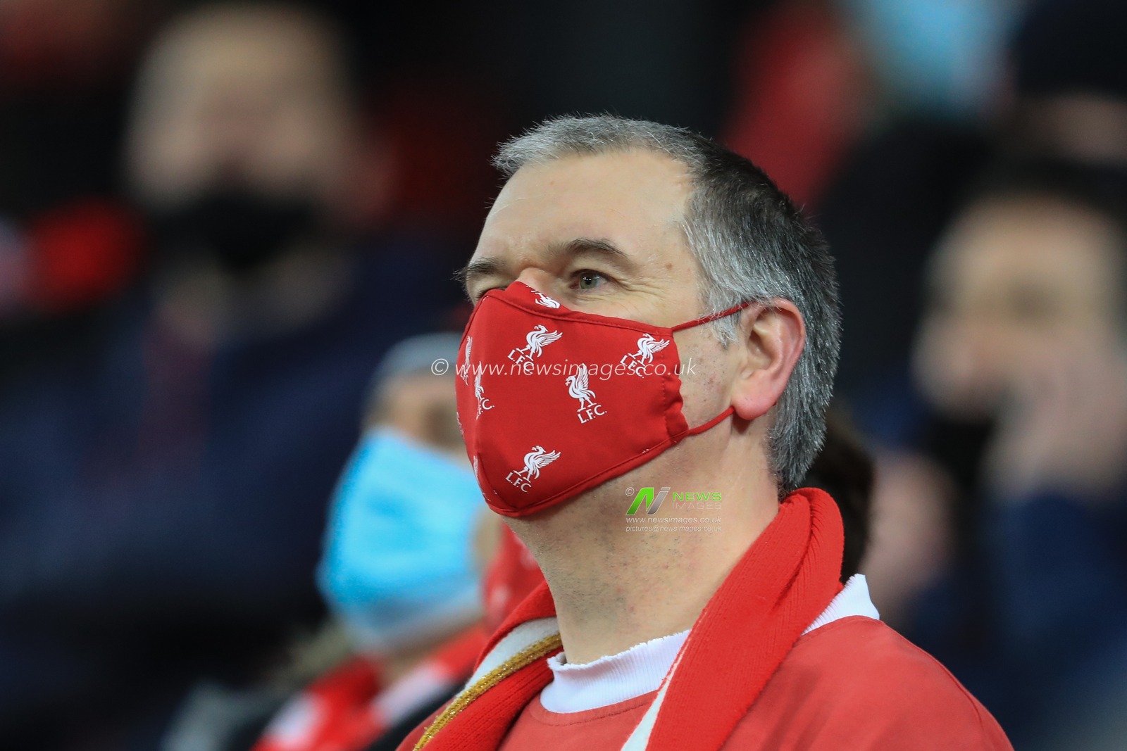 A Liverpool fan with a LFC face mask