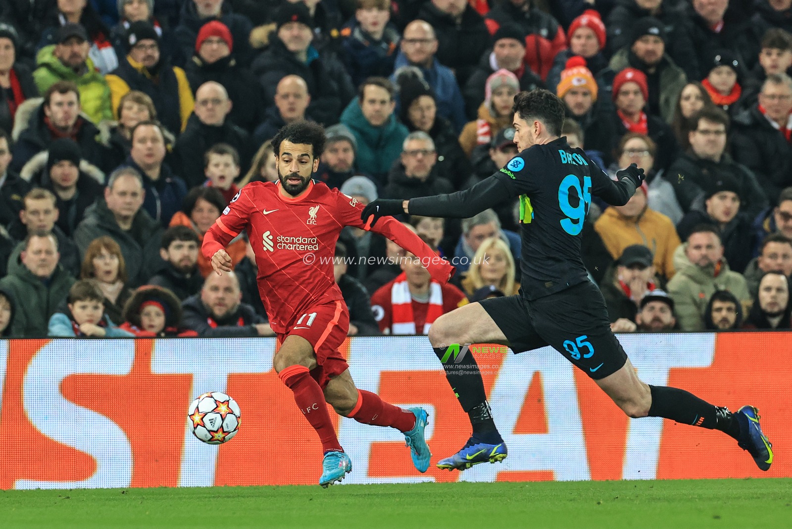 Mohamed Salah #11 of Liverpool breaks with the ball as Alessandro Bastoni #95 of Inter Milan pressures