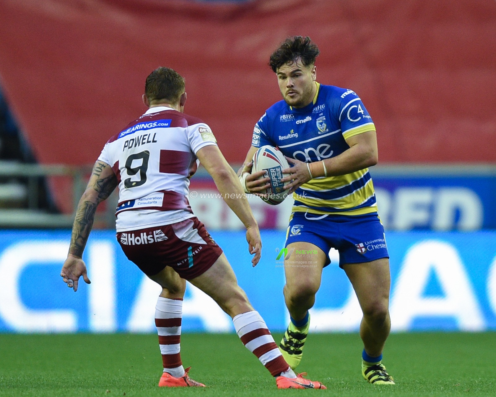 16th August 2019 , DW Stadium, Wigan, England;  Betfred Super League, Round 26, Wigan Warriors vs Warrington Wolves ; Joe Philbin of Warrington Wolves runs at Sam Powell (9) of Wigan Warriors 

Credit: Richard Long/News Images