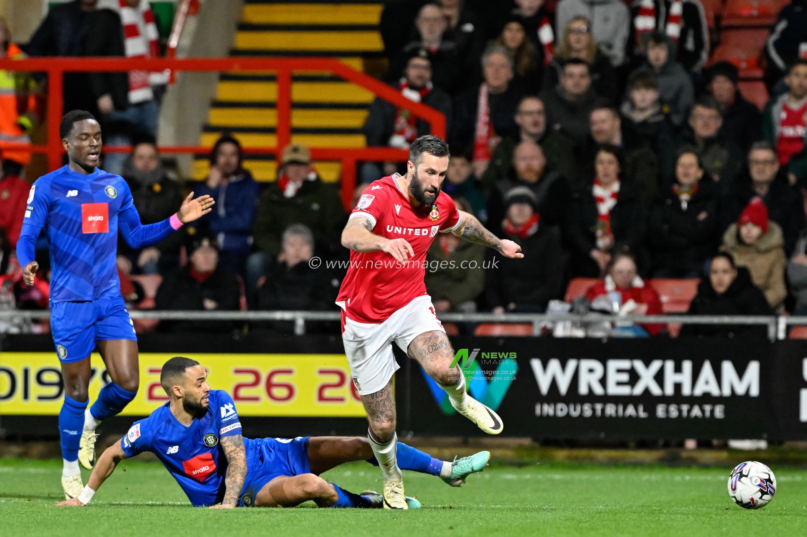 Warren Burrell of Harrogate Town tackles Ollie Palmer of Wrexham, during the Sky Bet League 2 match Wrexham vs Harrogate Town at SToK Cae Ras, Wrexham, United Kingdom, 12th March 2024

(Photo by Cody Froggatt/News Images)
