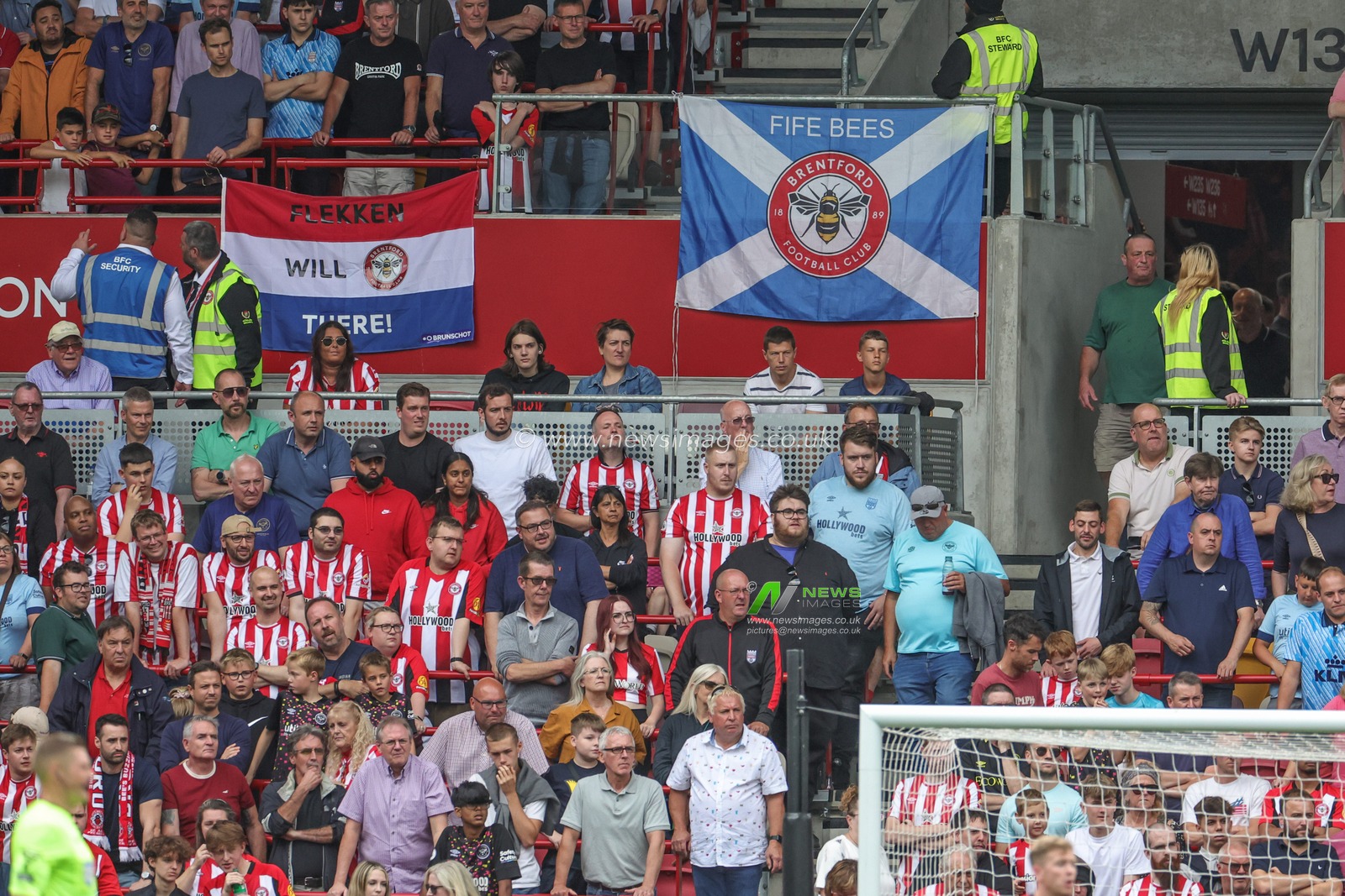 Brentford fans have flags up during the Premier League match Brentford vs Tottenham Hotspur at Brentford Community Stadium, London, United Kingdom, 13th August 2023

(Photo by Mark Cosgrove/News Images)
