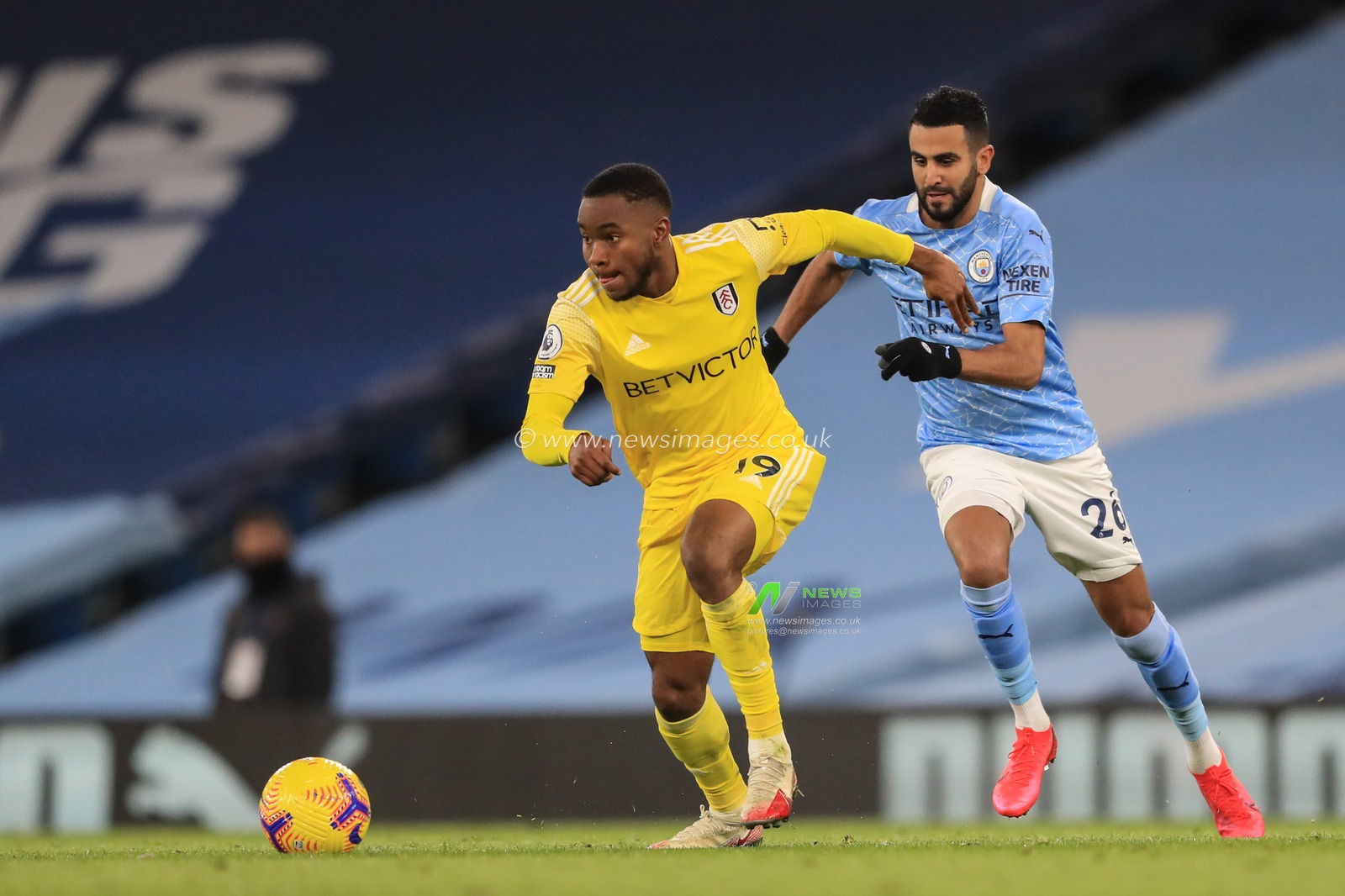 Ademola Lookman #19 of Fulham breaks with the ball as Riyad Mahrez #26 of Manchester City gives chase