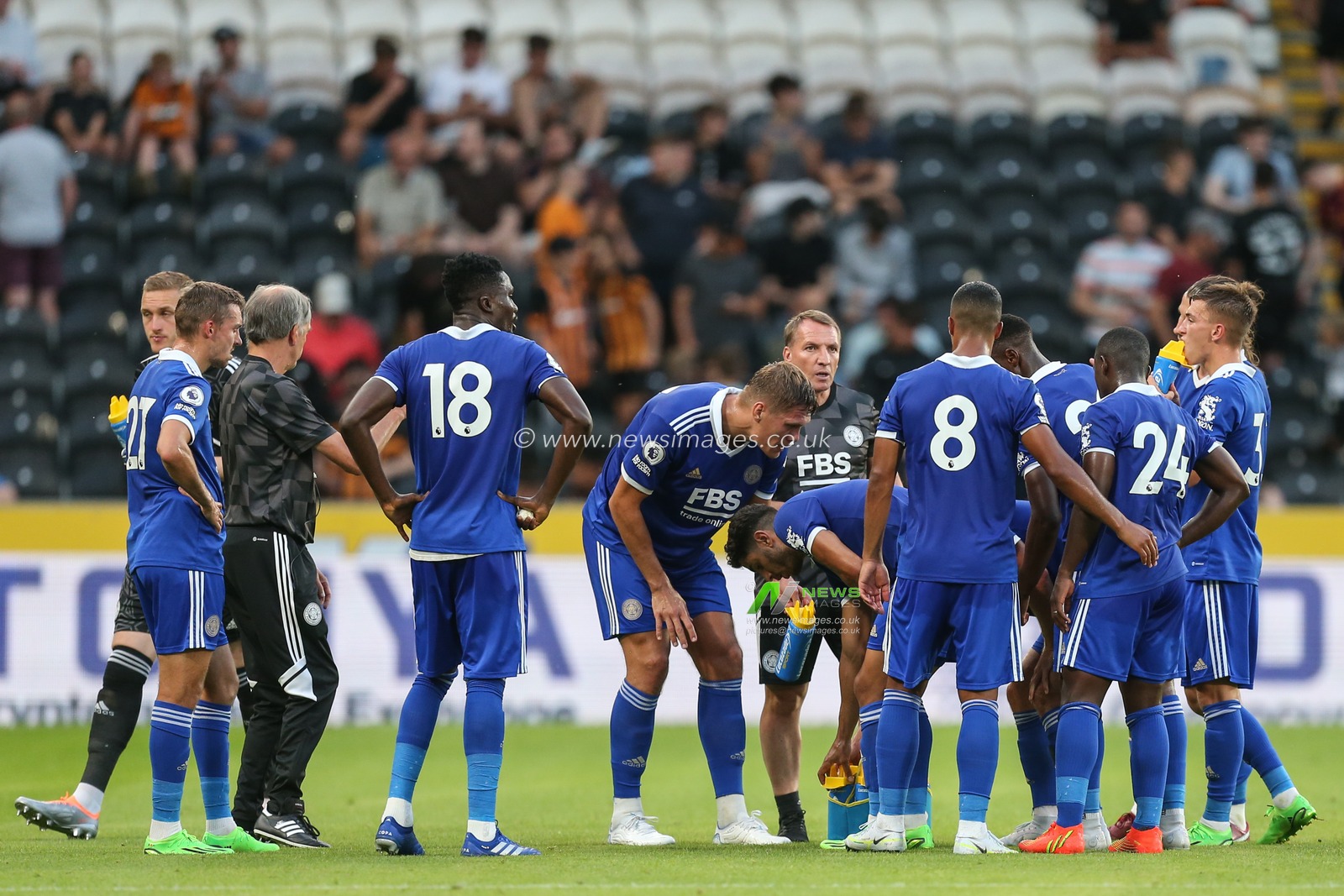 Brendan Rogers manager of Leicester City does his half time talk on the pitch
