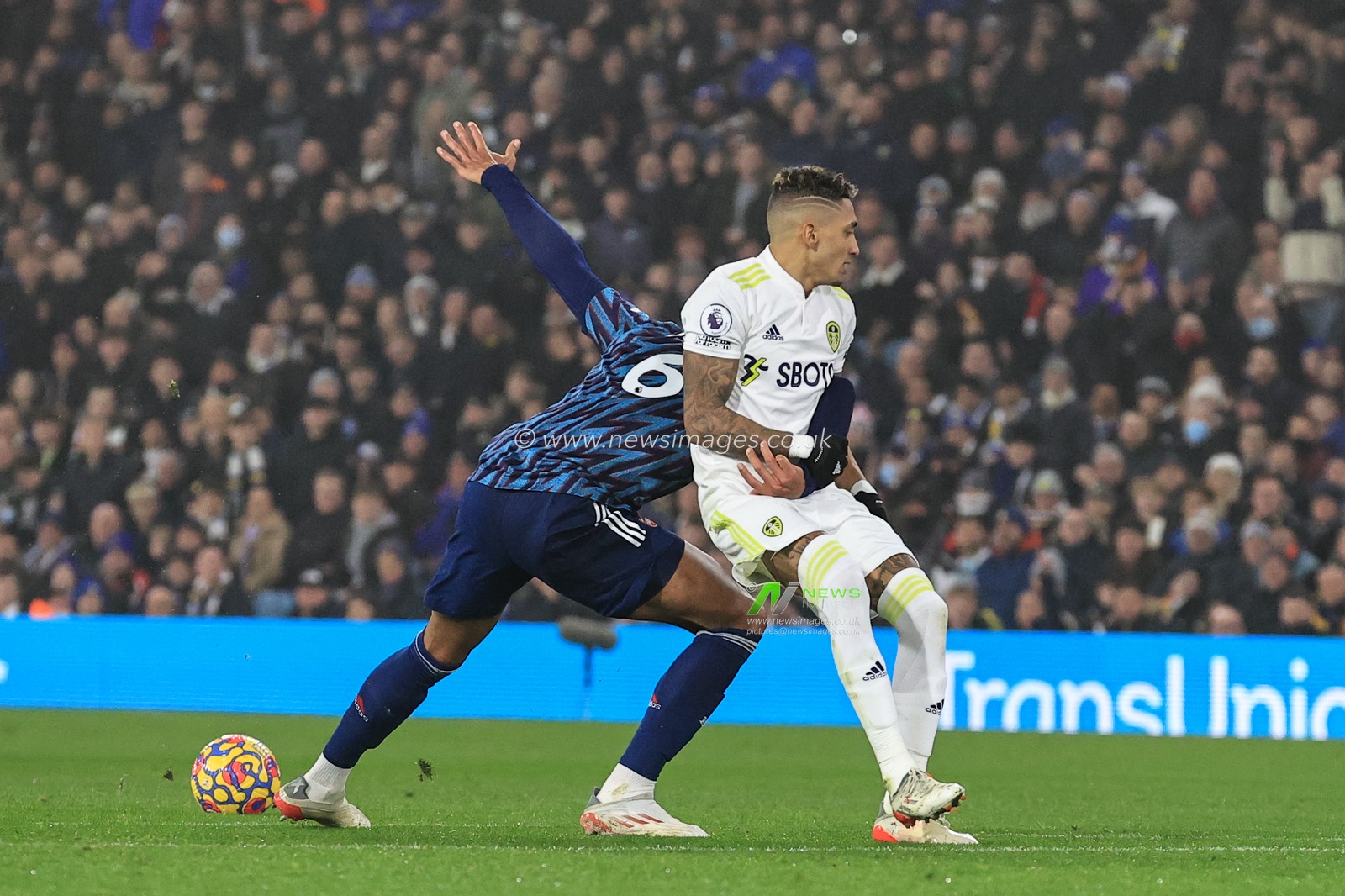 Raphinha #10 of Leeds United and Gabriel #6 of Arsenal clash, Arsenal win free-kick