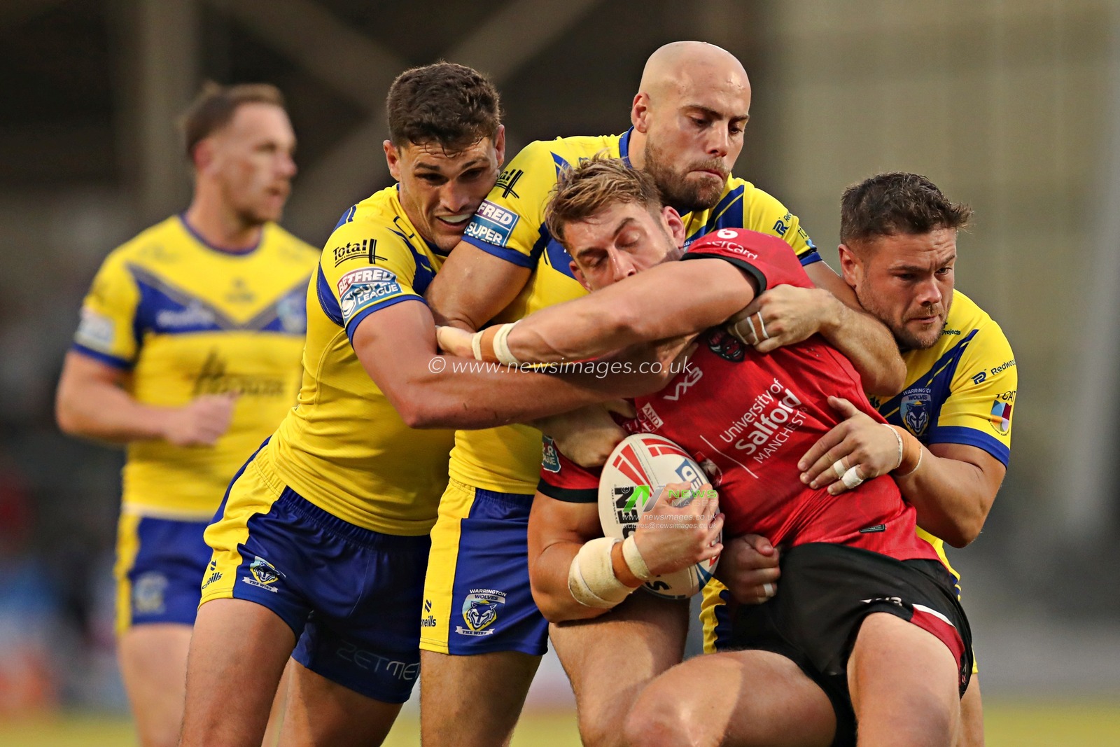 Sam Stone of Warrington Wolves, James Harrison of Warrington Wolves and Joe Philbin of Warrington Wolves tackle Jack Ormonroyd of Salford Red Devils during the Betfred Super League round 17 match Salford Red Devils vs Warrington Wolves at Salford Community Stadium, Eccles, United Kingdom, 4th July 2025(Photo by Sam Eaden/News Images)