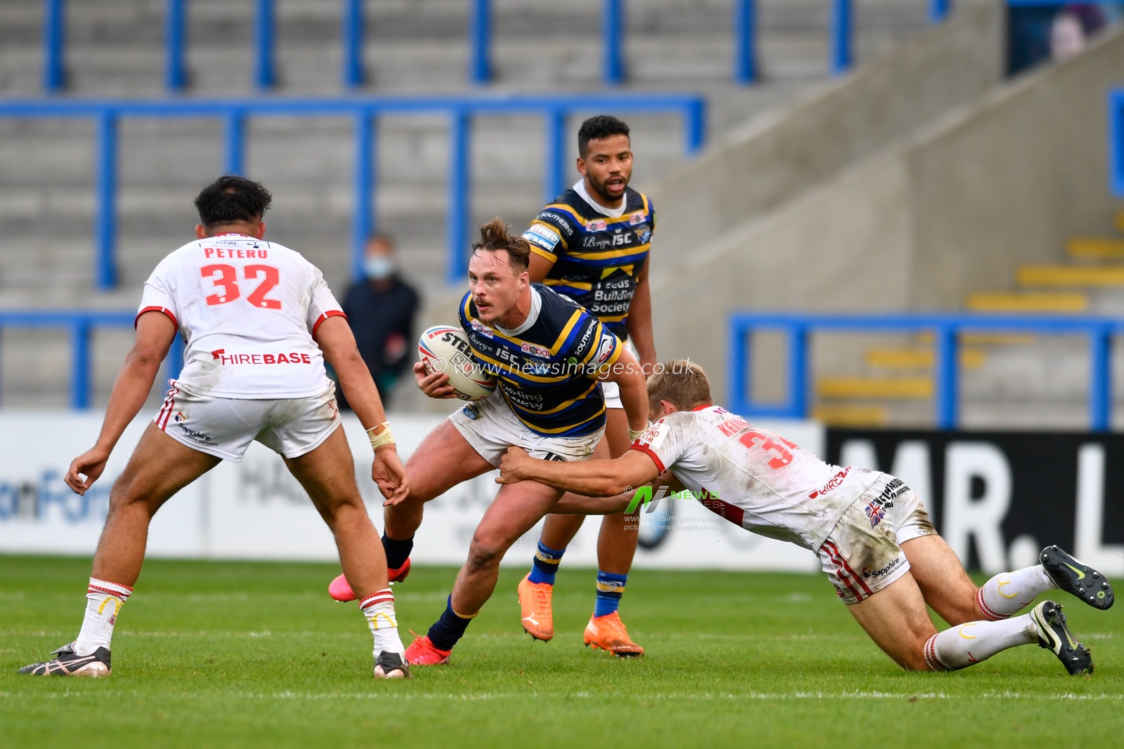 James Donaldson (25) of Leeds Rhinos is tackled by Jimmy Keinhorst (34) of Hull KR