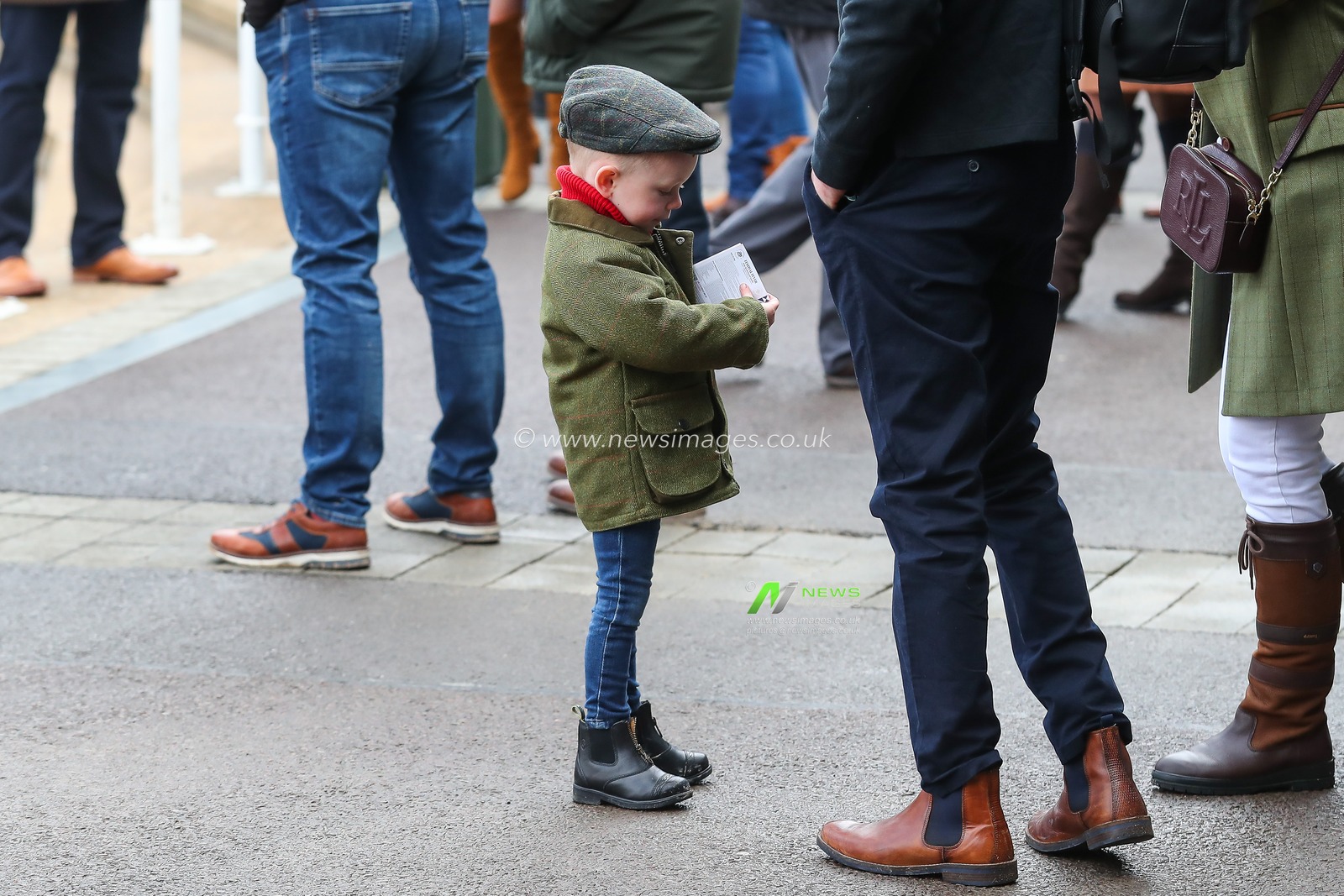 A young racegoers checks his form guide begin to arrive ahead of the Cheltenham Festival 2025 Style Wednesday at Cheltenham Racecourse, Cheltenham, United Kingdom, 12th March 2025

(Photo by Gareth Evans/News Images)