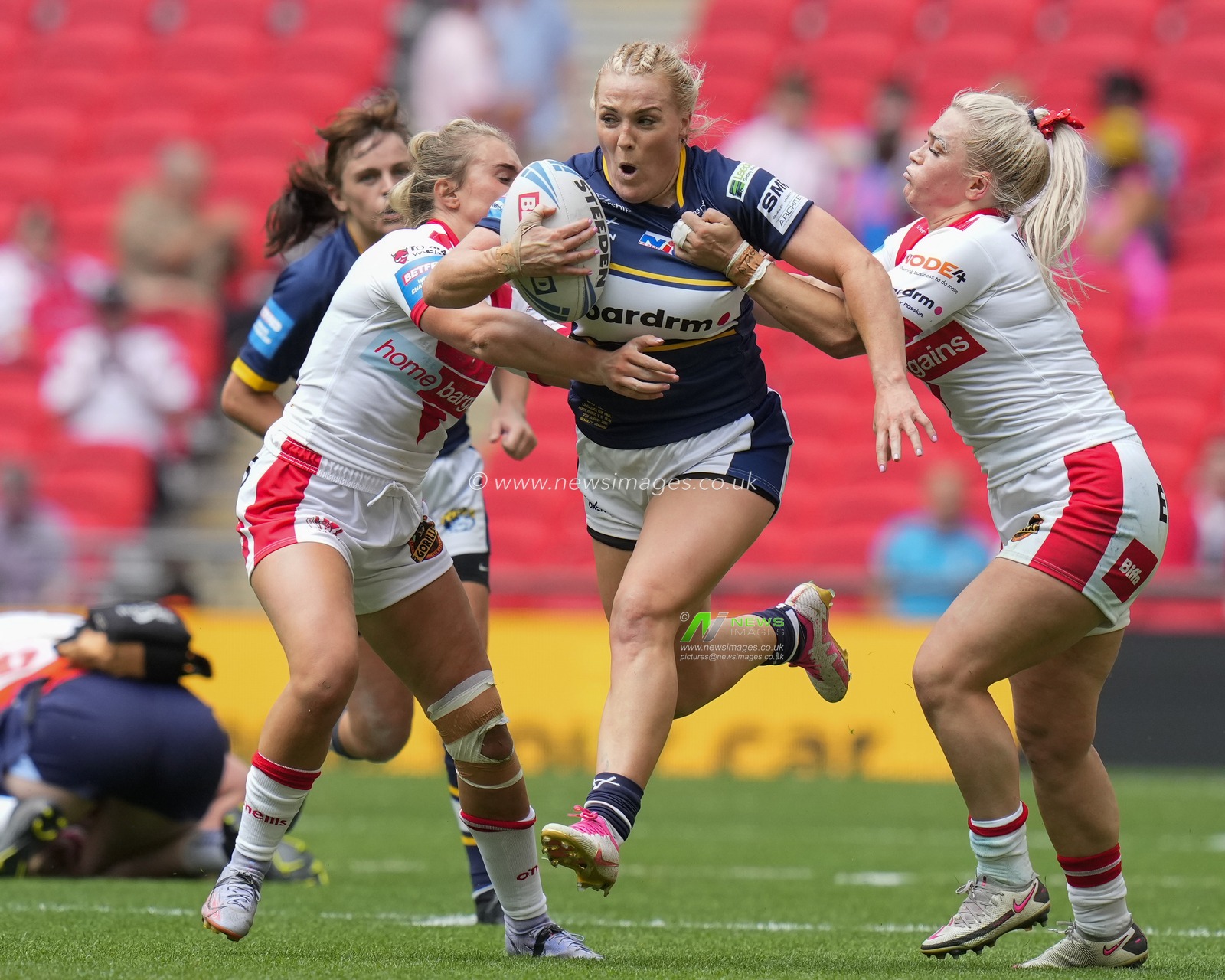 Amy Hardcastle #11 of Leeds Rhinos breaks past Shona Hoyle #8 of St. Helens during the Betfred Womens Challenge Cup Final match Leeds Rhinos vs St Helens at Wembley Stadium, London, United Kingdom, 12th August 2023

(Photo by Steve Flynn/News Images)