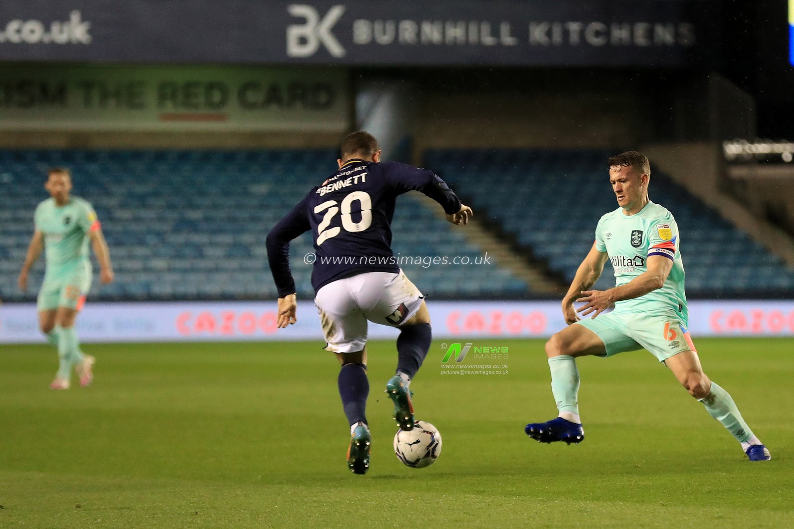 Jonathan Hogg #6 of Huddersfield Town and Mason Bennett #20 of Millwall.