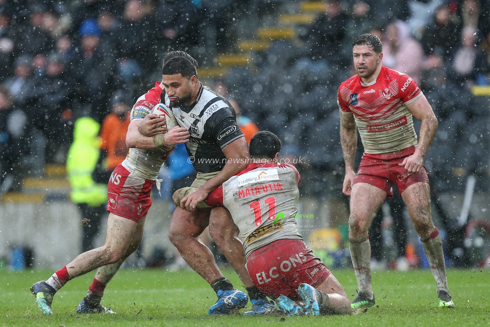 Chris Satae (10) of Hull FC is stopped by the St Helens defence