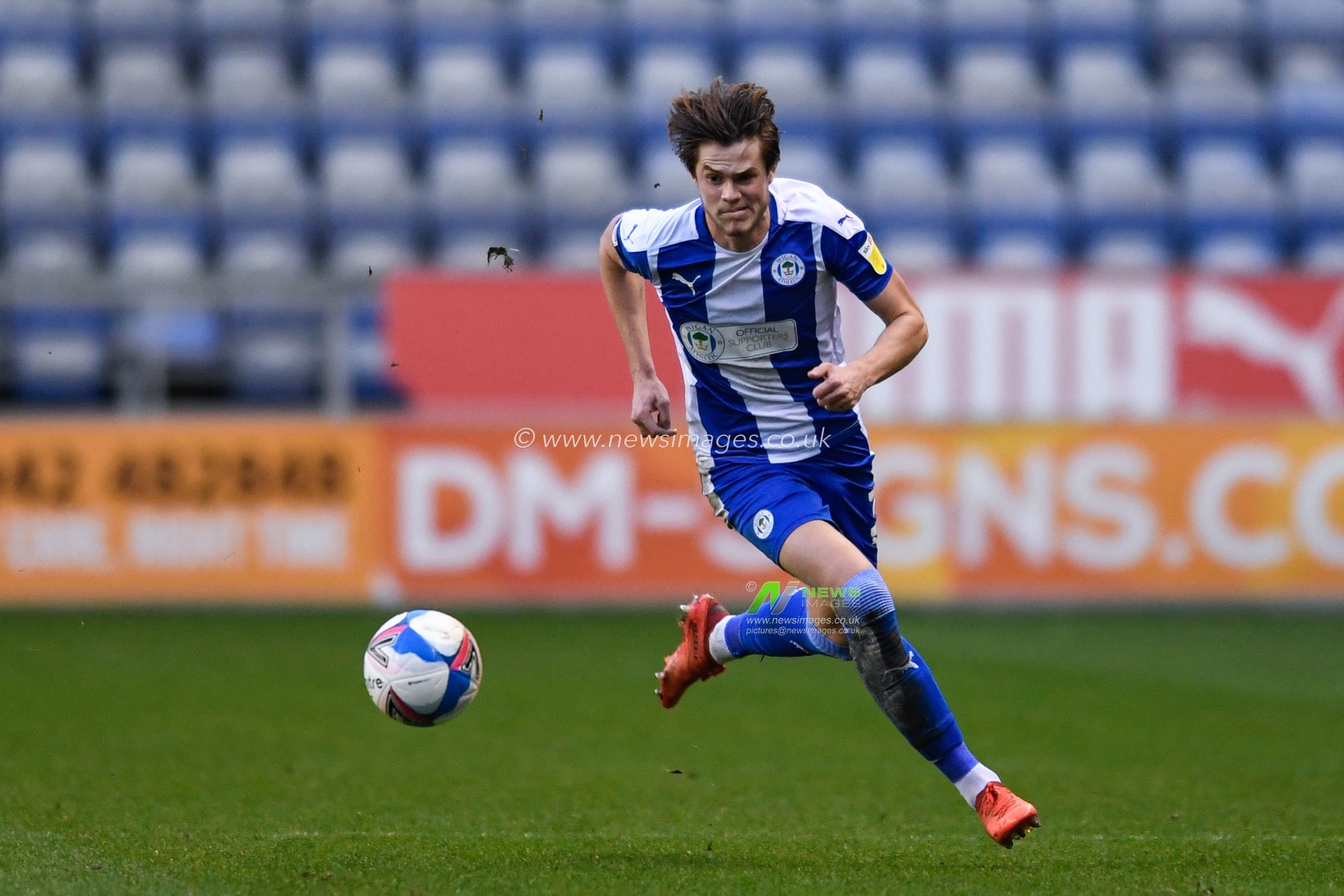 Tom Pearce #3 of Wigan Athletic runs forward with the ball