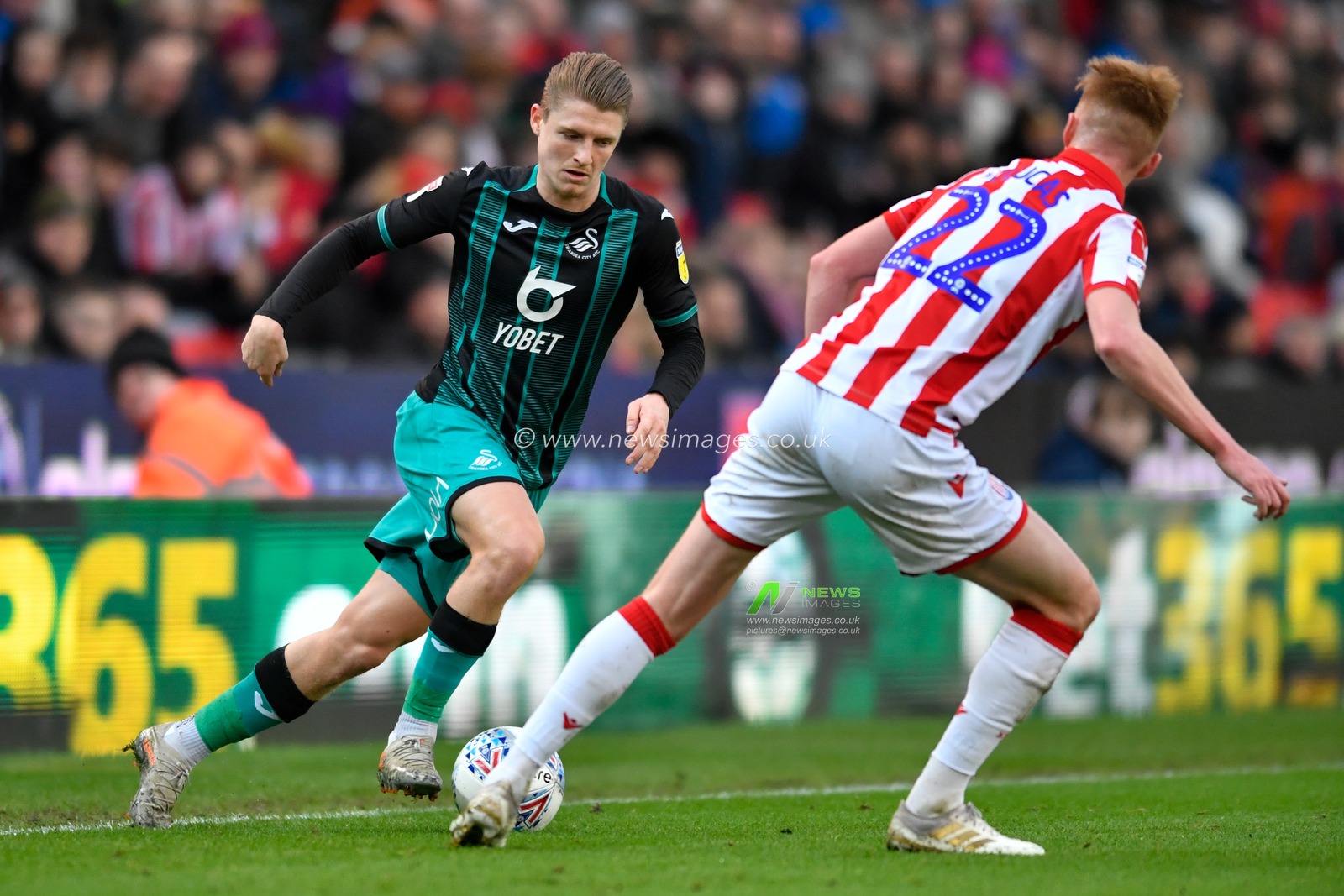 25th January 2020, Bet365 Stadium, Stoke-on-Trent, England; Sky Bet Championship, Stoke City v Swansea City : George Byers (28) of Swansea City attempts to run past Sam Clucas (22) of Stoke City