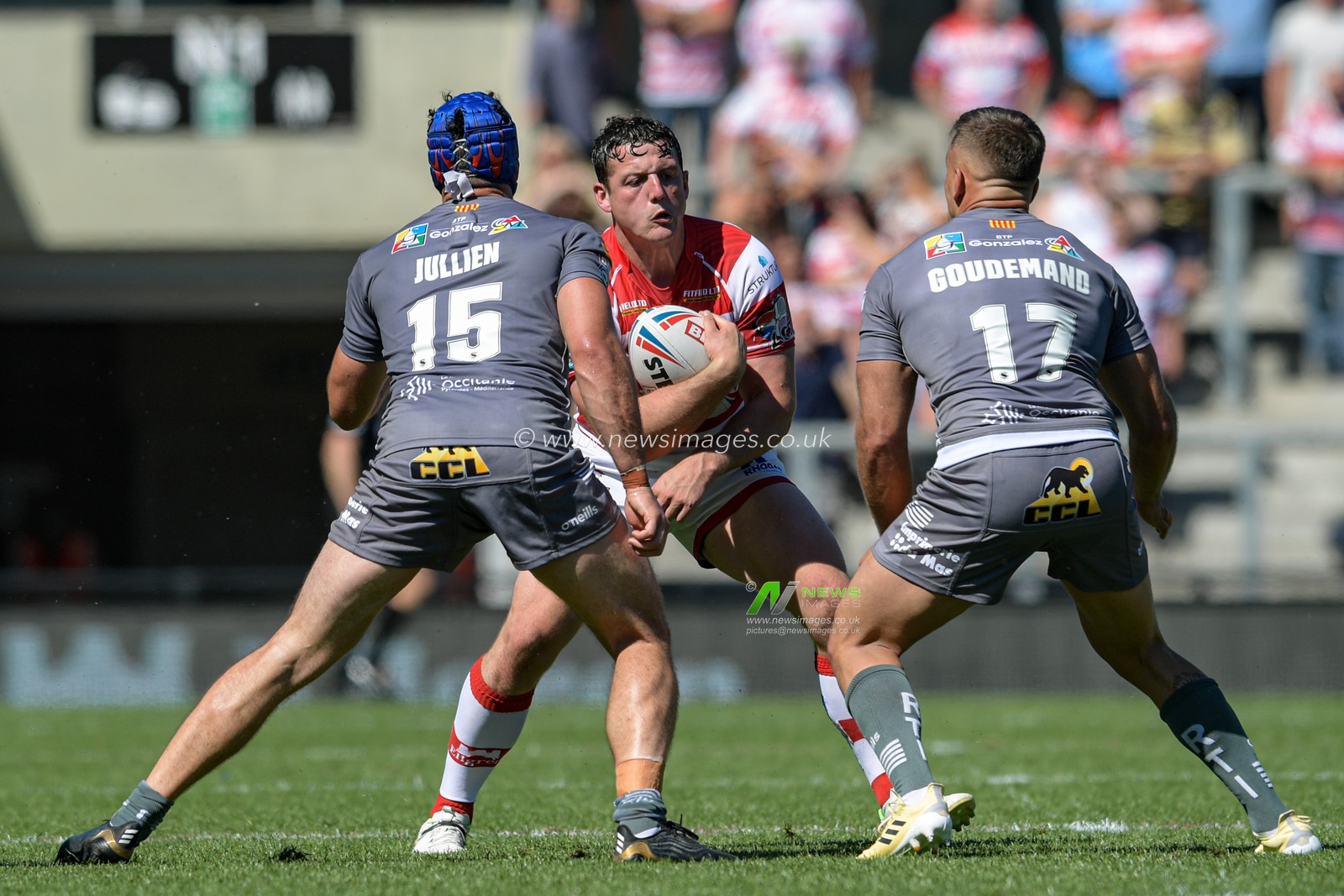 Matty Gee (18) of Leigh Centurions looks for a way past Benjamin Jullien (15) of Catalans Dragons and Mickael Goudemand (17) of Catalans Dragons