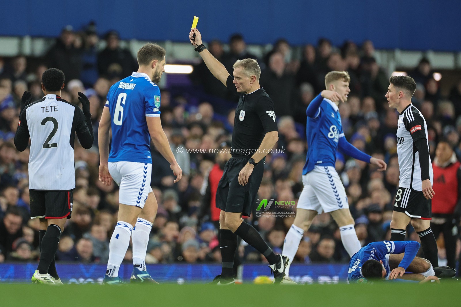 Referee Graham Scott shows Kenny Tete of Fulham a yellow card during the Carabao Cup Quarter Final match Everton vs Fulham at Goodison Park, Liverpool, United Kingdom, 19th December 2023

(Photo by Mark Cosgrove/News Images)