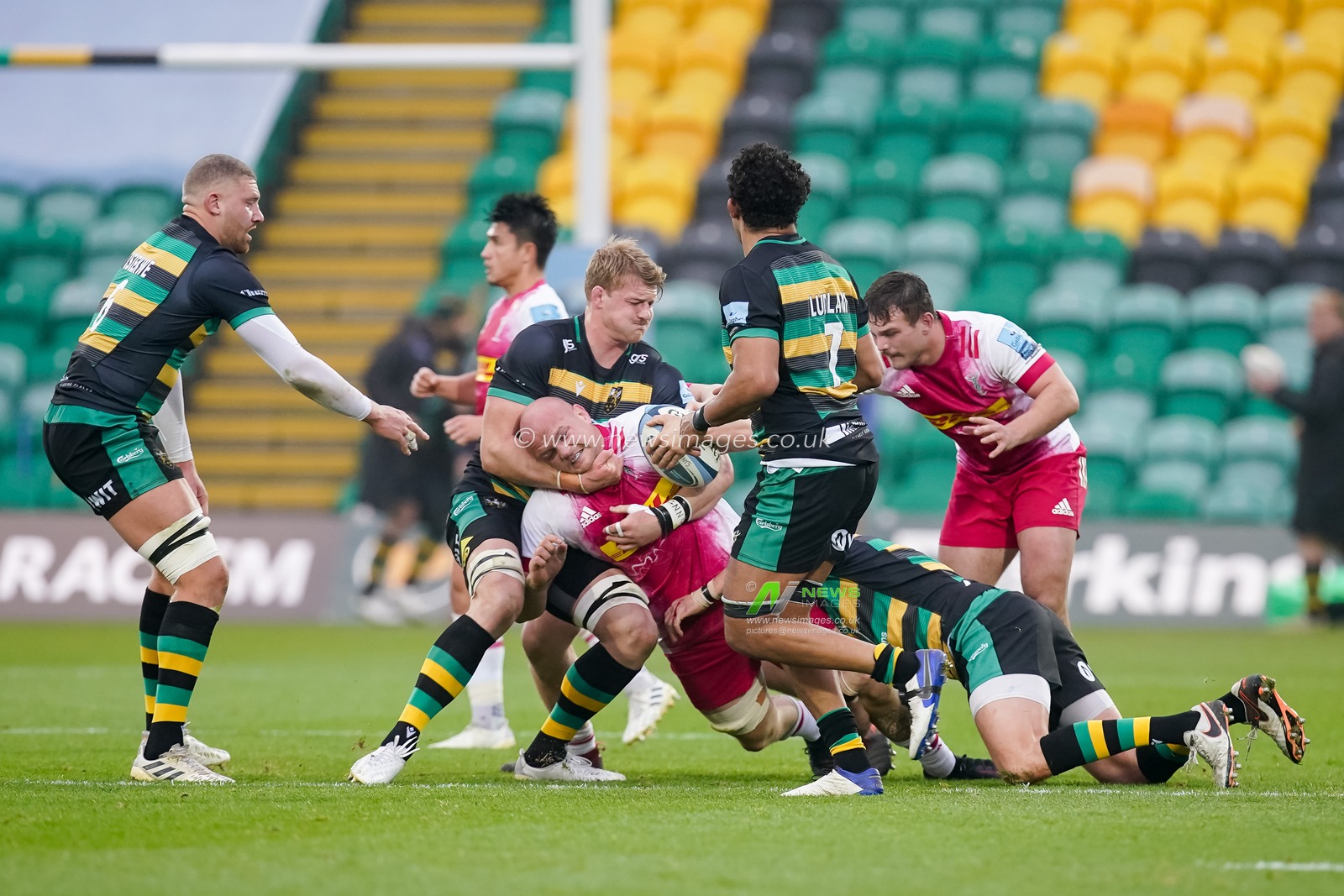Tom Lawday #6 of Harlequins battles his way through the Northants defence