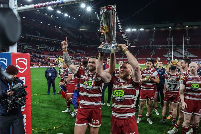 Kaide Ellis of Wigan Warriors and Luke Thompson of Wigan Warriors lift the Betfred Super League Grand Final trophy during the Betfred Super League Grand Final match Wigan Warriors vs Hull KR at Old Trafford, Manchester, United Kingdom, 12th October 2024

(Photo by Mark Cosgrove/News Images)