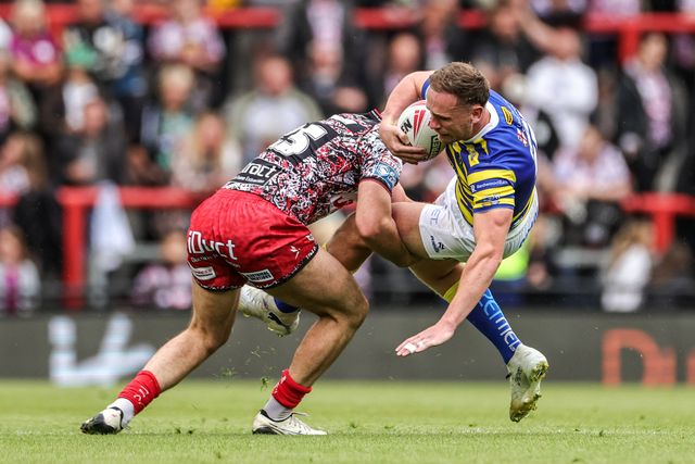 Ben Currie of Warrington Wolves is tackled by Louis Brogan of Leigh Leopards during the Betfred Super League round 20 match Leigh Leopards vs Warrington Wolves at Leigh Sports Village, Leigh, United Kingdom on 25 July 2026

(Photo by Alfie Cosgrove/News Images)