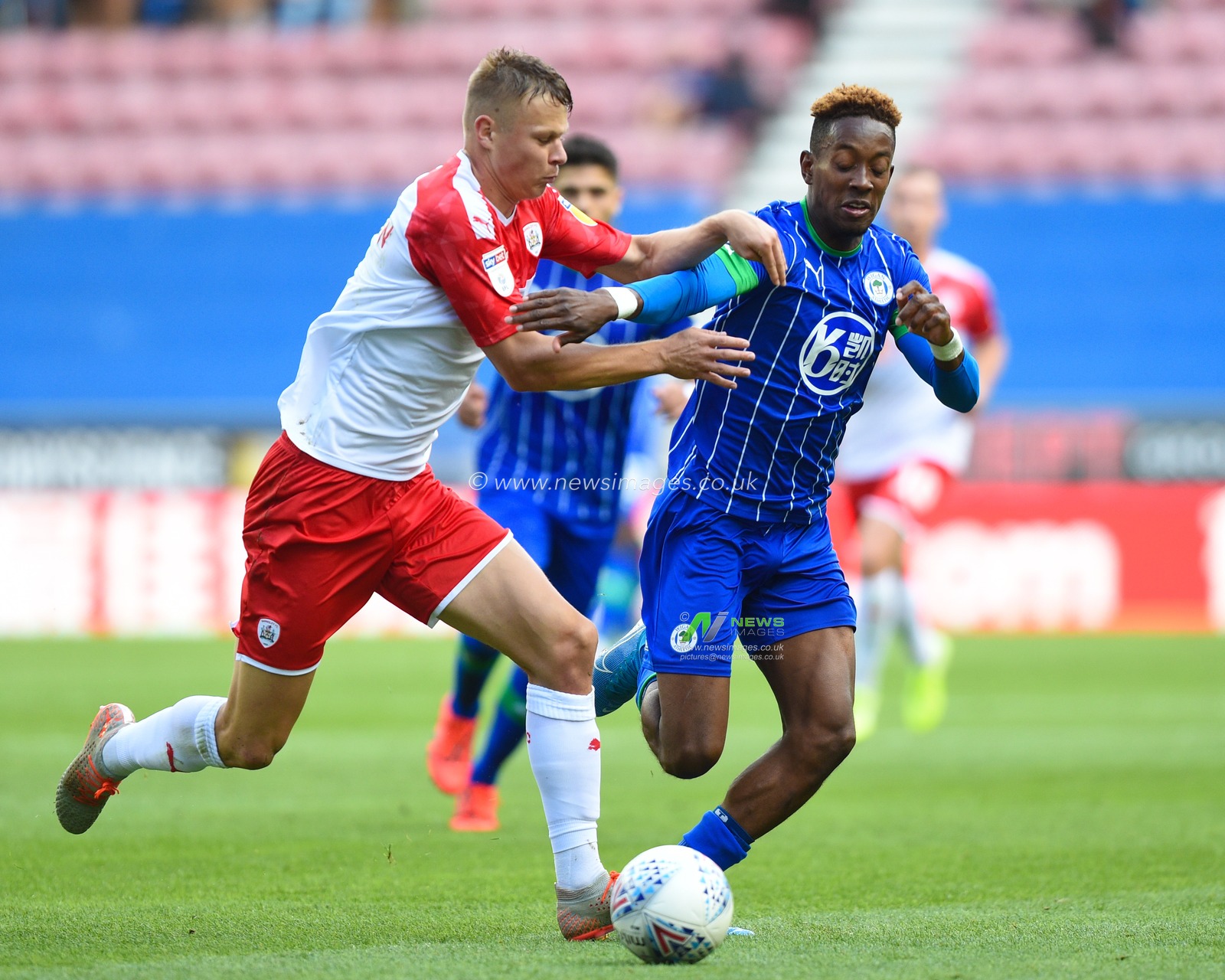 31st August  2019, DW Stadium, Wigan, England; Sky Bet Championship Football, Wigan Athletic vs Barnsley ; Jamal Lowe (9) of Wigan Athletic and Mads Juel Andersen (6) of Barnsley in contension


Credit:Richard Long/News Images

English Football League images are subject to DataCo Licence