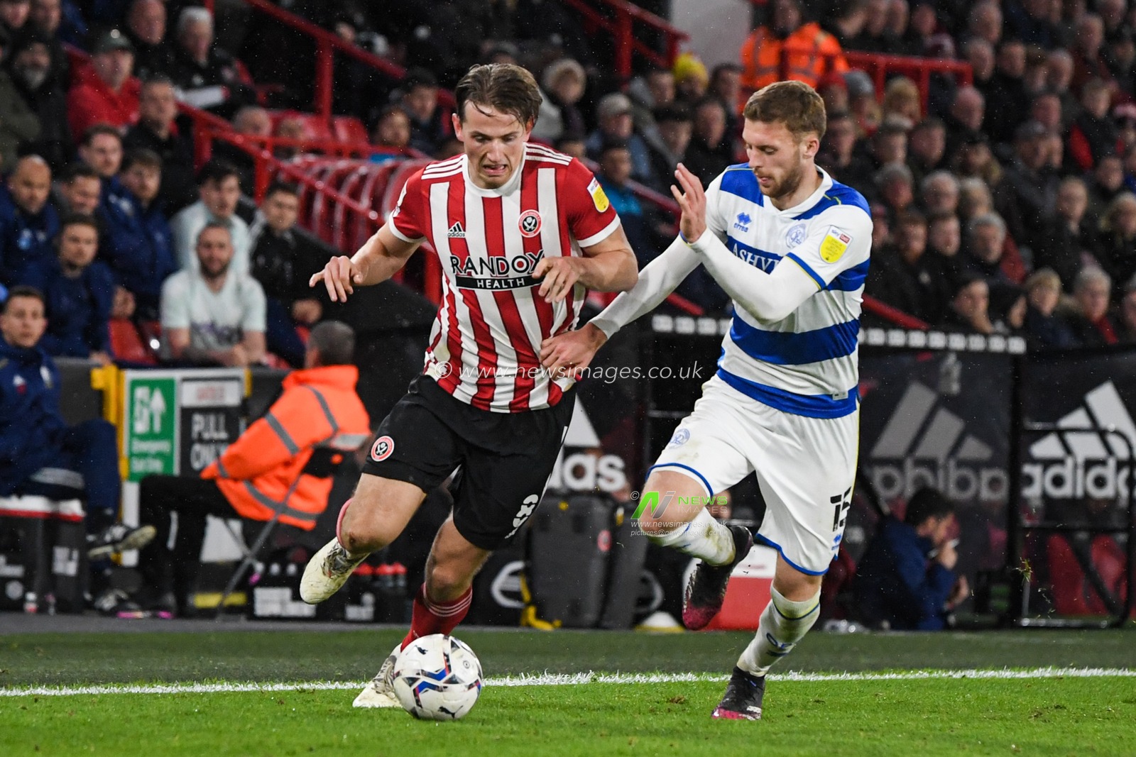 Sander Berge #8 of Sheffield United competes with Sam Field #15 of Queens Park Rangers for the ball