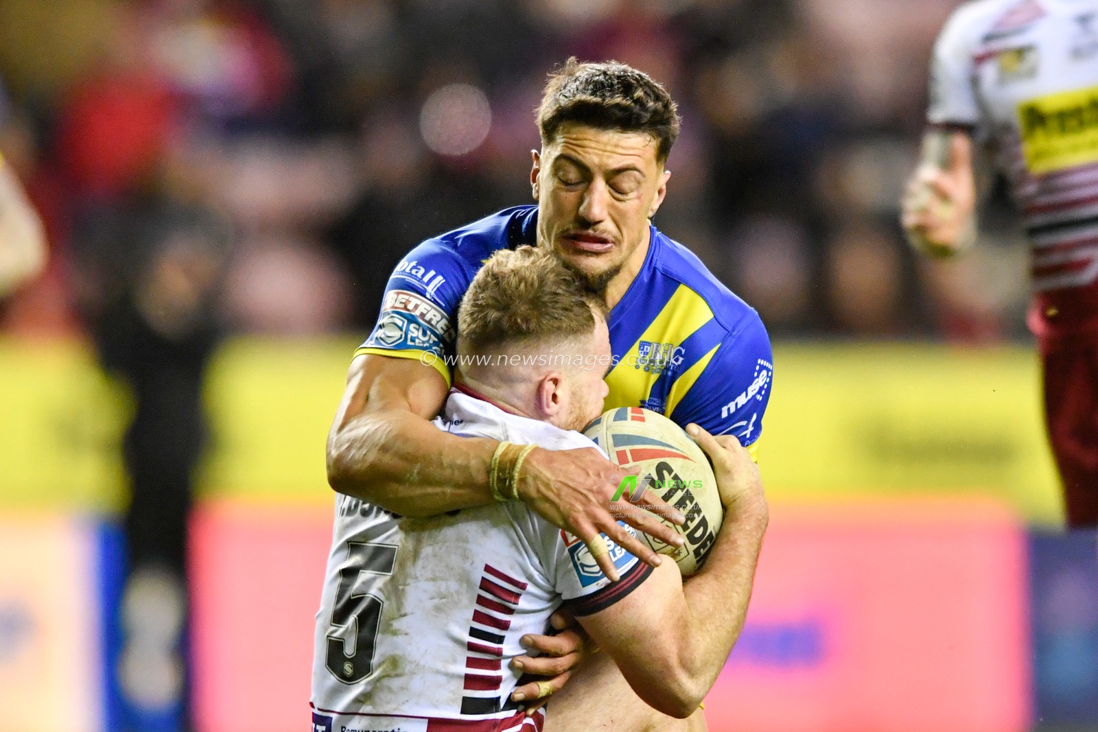 30th January 2020, DW Stadium, Wigan, England; Betfred Super League, Wigan Warriors v Warrington Wolves : Anthony Gelling (3) of Warrington Wolves tackles Joe Burgess (5) of Wigan Warriors