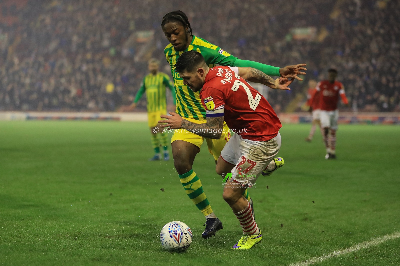 26th December 2019, Oakwell, Barnsley, England; Sky Bet Championship, Barnsley v West Bromwich Albion : Romaine Sawyers (19) of West Bromwich Albion fouls Alex Mowatt (27) of Barnsley 

Credit: Mark Cosgrove/News Images